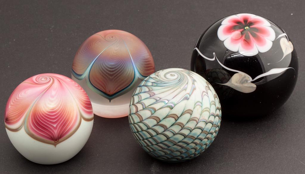 STUART ABELMAN STUDIO ART GLASS PAPERWEIGHTS, LOT OF FO: STUART ABELMAN STUDIO ART GLASS PAPERWEIGHTS, LOT OF FOUR, including floral, pulled feather and swirl designs, each signed, dated 1985 and 1989. 2 1/4" to 2 7/8" D. Provenance: Collection of Lloyd and