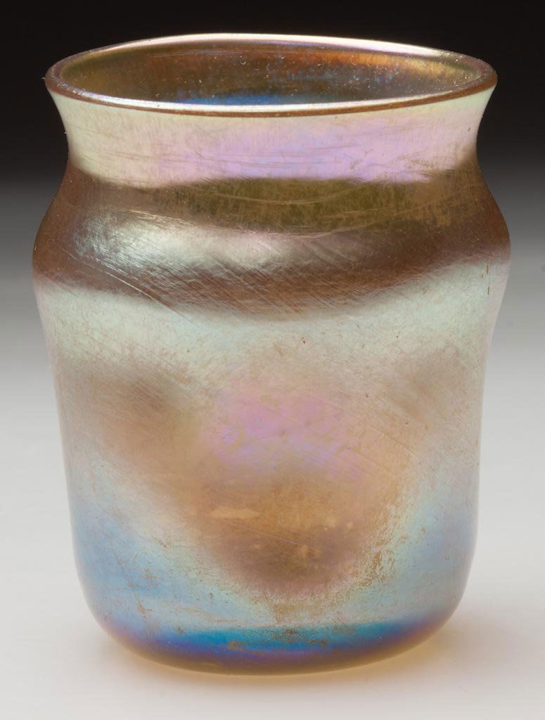 TIFFANY FAVRILE TOOTHPICK HOLDER / LIQUOR TUMBLER: TIFFANY FAVRILE TOOTHPICK HOLDER / LIQUOR TUMBLER, gold iridescent, circular form with four pinched sides, signed "L.C.T. R3110" at the polished pontil mark. Louis Comfort Tiffany & Co. First quarter
