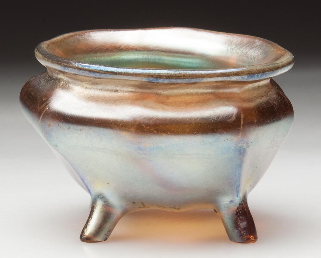 TIFFANY FAVRILE OPEN SALT: TIFFANY FAVRILE OPEN SALT, gold iridescent, witch's pot form with octagonal body raised on four full-height feet, signed "L.C.T." outside the polished pontil mark. Louis Comfort Tiffany & Co. First qu