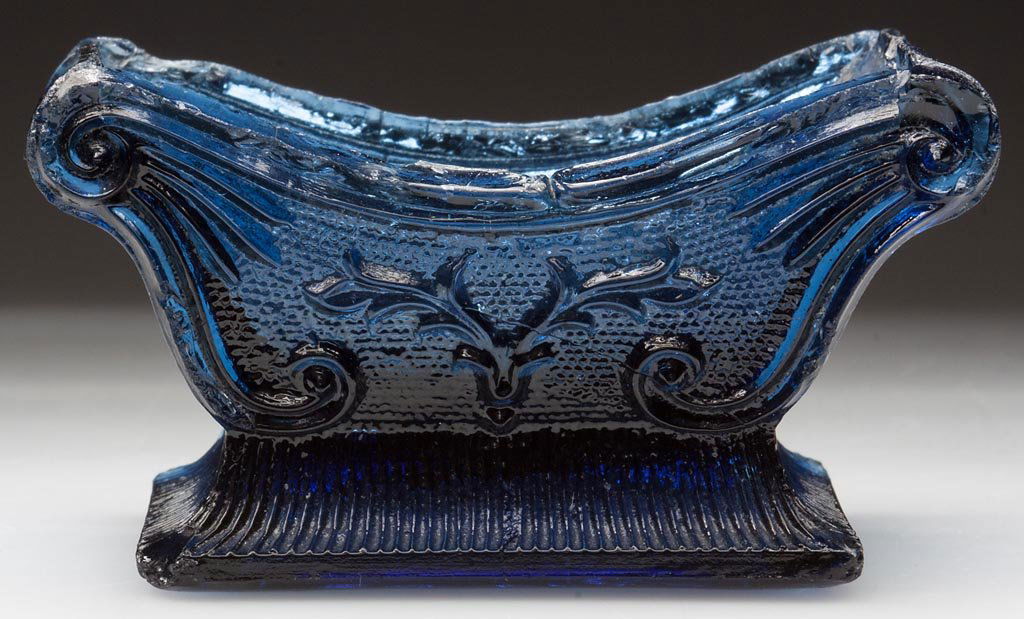 SN-1C STAG'S HORN PRESSED SALT: SN-1C STAG'S HORN PRESSED SALT, unlisted steel blue, 20 rays under base. Probably extremely rare. Possibly Boston & Sandwich Glass Co. 1835-1850. 1 3/4" H, 2" x 3 1/8". Literature: Parallels Neal, p.