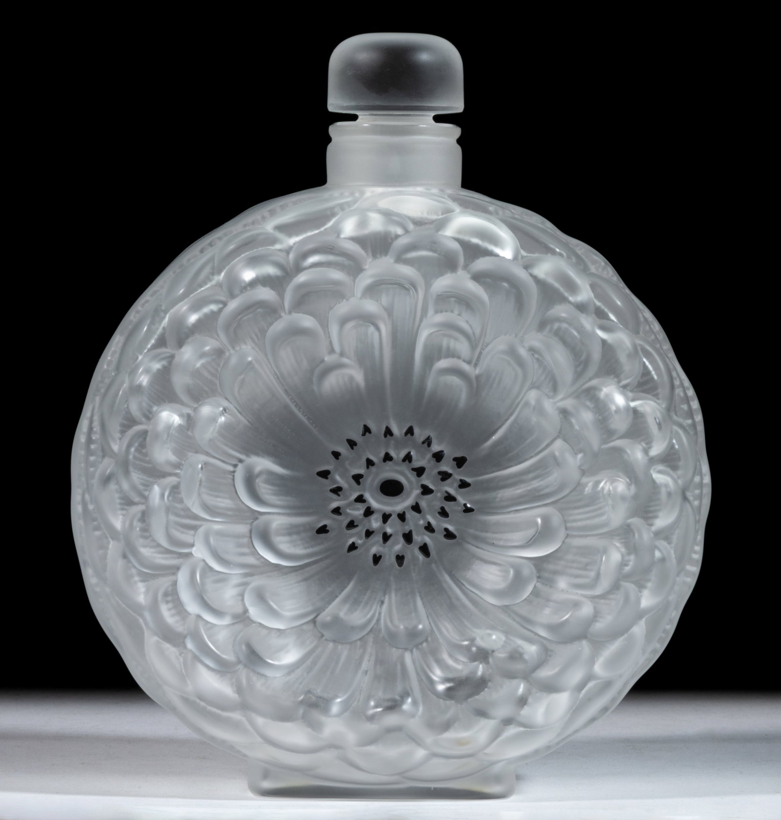 LALIQUE DAHLIA ART GLASS PERFUME BOTTLE: LALIQUE DAHLIA ART GLASS PERFUME BOTTLE, frosted colorless with black staining, signed in acid-stamped script to underside "LALIQUE FRANCE", with original stopper. Lalique et 