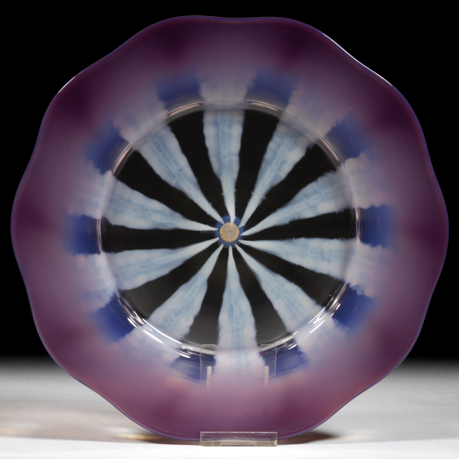 TIFFANY FAVRILE PASTEL ART GLASS PLATE: TIFFANY FAVRILE PASTEL ART GLASS PLATE, purple and colorless with opalescent design, signed to underside, "L.C.Tiffany Favrile", retains original trademark sticker to the polished ponti