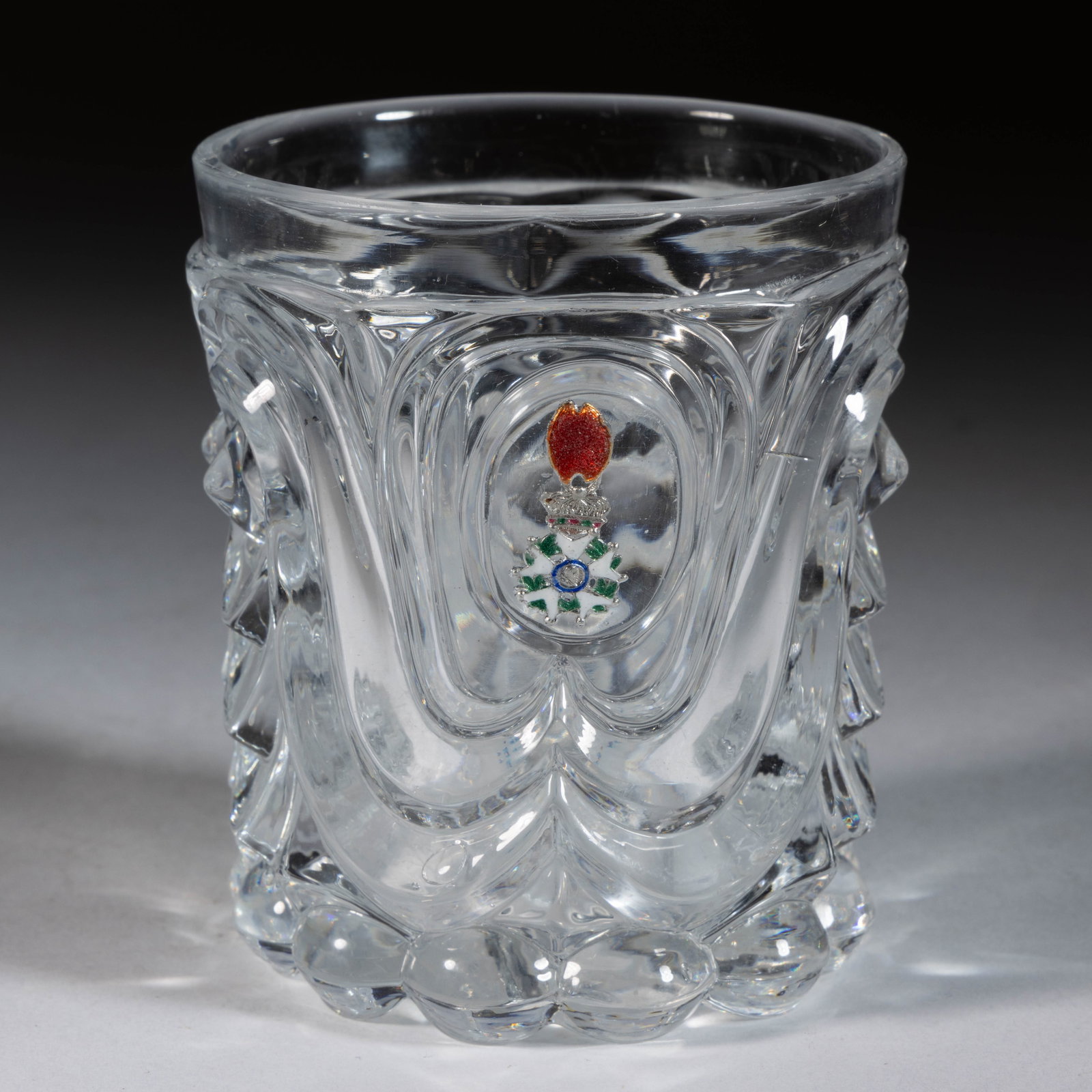 BACCARAT ATTRIBUTED LEGION OF HONOR GOLD FOIL INCRUSTED / SULPHIDE PRESSURE-MOLDED TUMBLER: BACCARAT ATTRIBUTED LEGION OF HONOR GOLD FOIL INCRUSTED / SULPHIDE PRESSURE-MOLDED TUMBLER, colorless, having an Eye and Scale and Swag pattern with central reserve holding a gold foil Legion of Honor