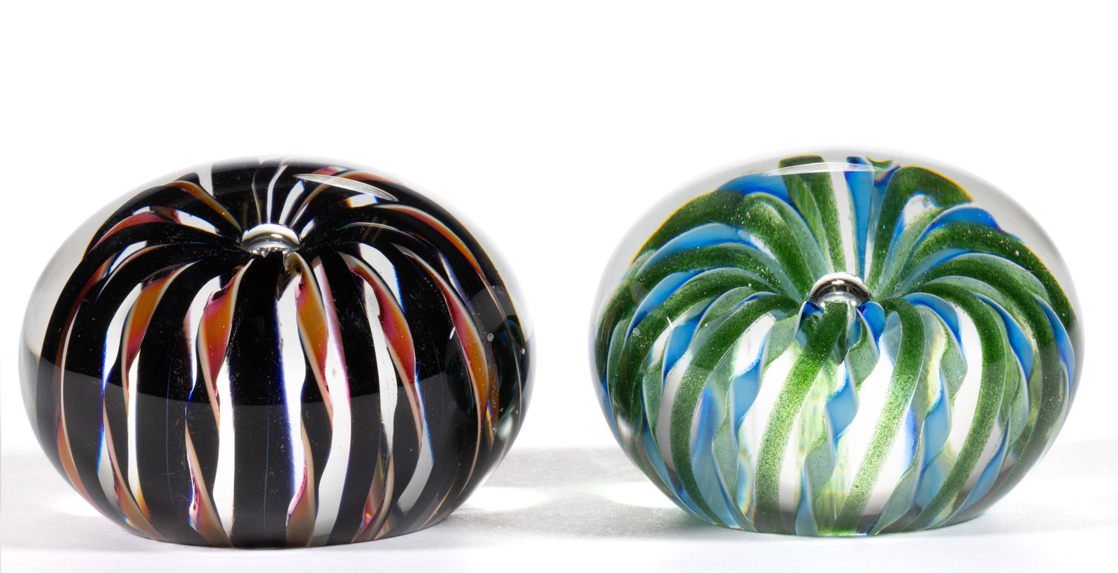 DAVID LOTTON (AMERICAN, B. 1960) CROWN STUDIO ART GLASS PAPERWEIGHTS, LOT OF TWO: DAVID LOTTON (AMERICAN, B. 1960) CROWN STUDIO ART GLASS PAPERWEIGHTS, LOT OF TWO, central controlled bubble with one having black stripes followed by black and orange opaque twists, other having avent