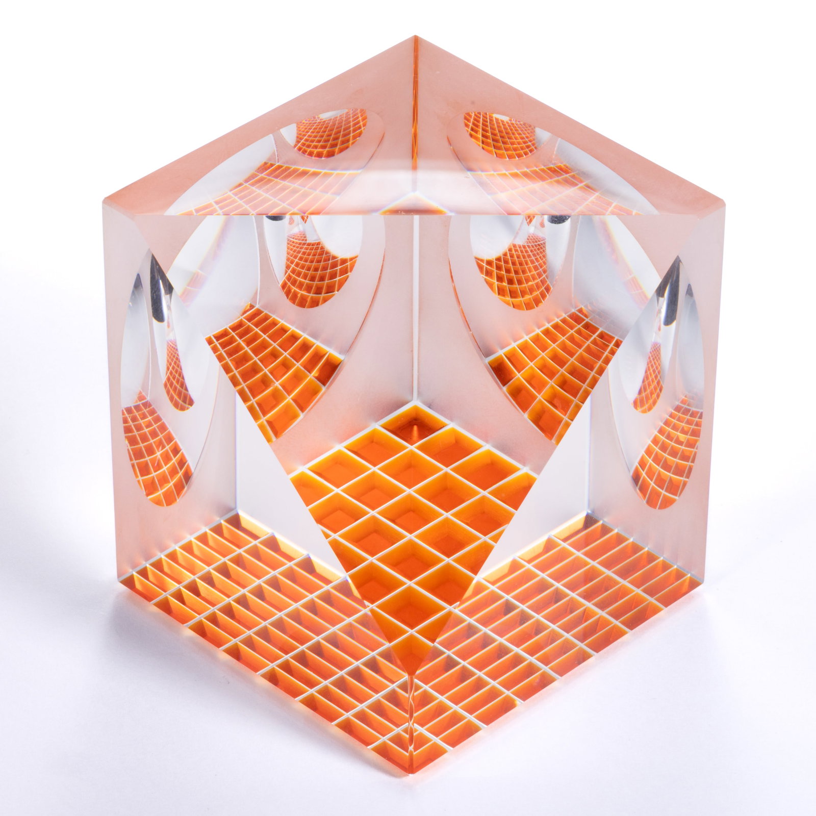 JAMES SHAW (AMERICAN, B. 1953) SPACE CUBE OPTICAL CUT STUDIO ART GLASS PAPERWEIGHT: JAMES SHAW (AMERICAN, B. 1953) SPACE CUBE OPTICAL CUT STUDIO ART GLASS PAPERWEIGHT, orange base, cut with geometrical shapes, such as triangles, circles and squares in a manner which creates opti