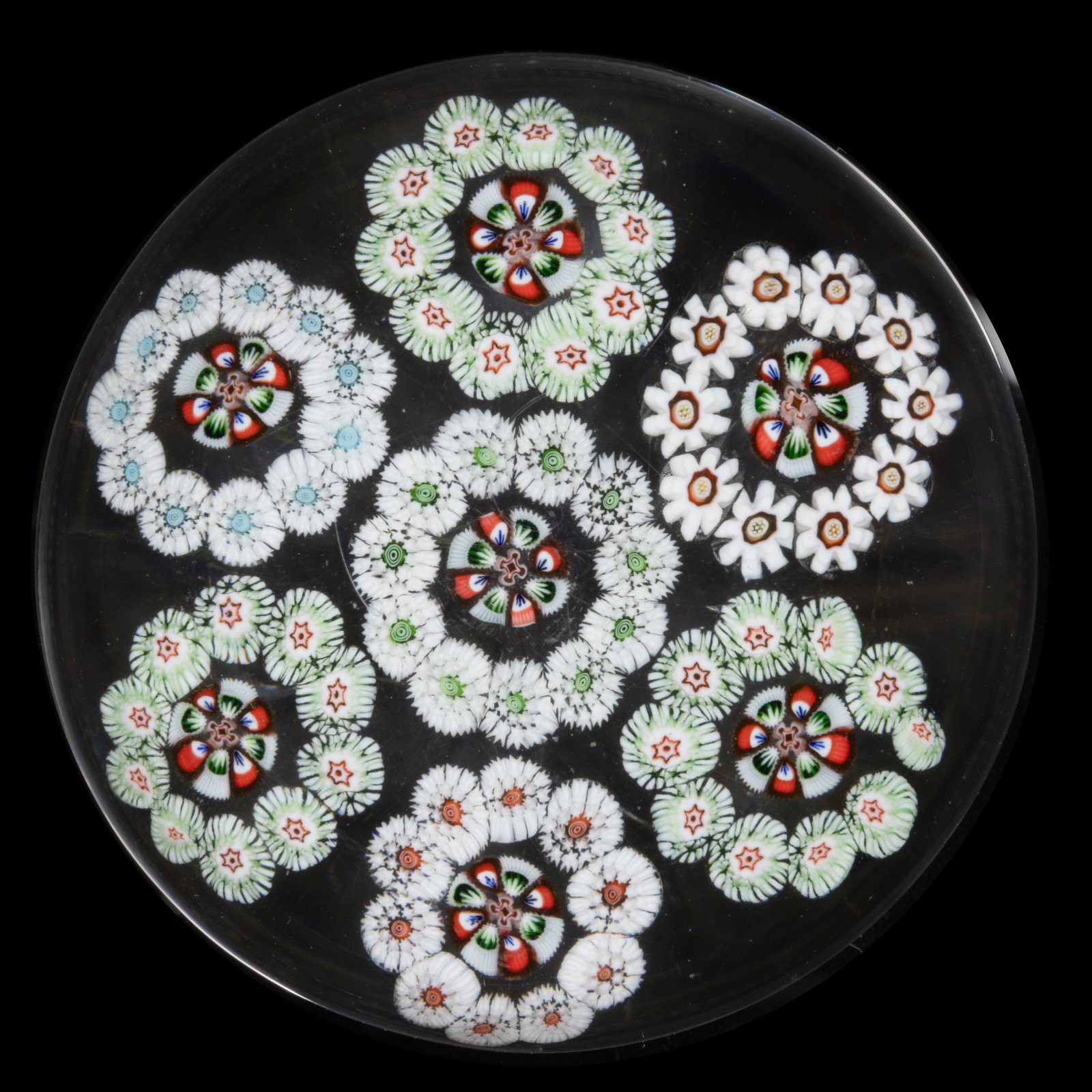 ANTIQUE BACCARAT SEVEN RONDELS MILLEFIORI ART GLASS PAPERWEIGHT: ANTIQUE BACCARAT SEVEN RONDELS MILLEFIORI ART GLASS PAPERWEIGHT, comprising a central circlet with six exterior circlets, each having a white, red, and green interior arrowhead cane, three s