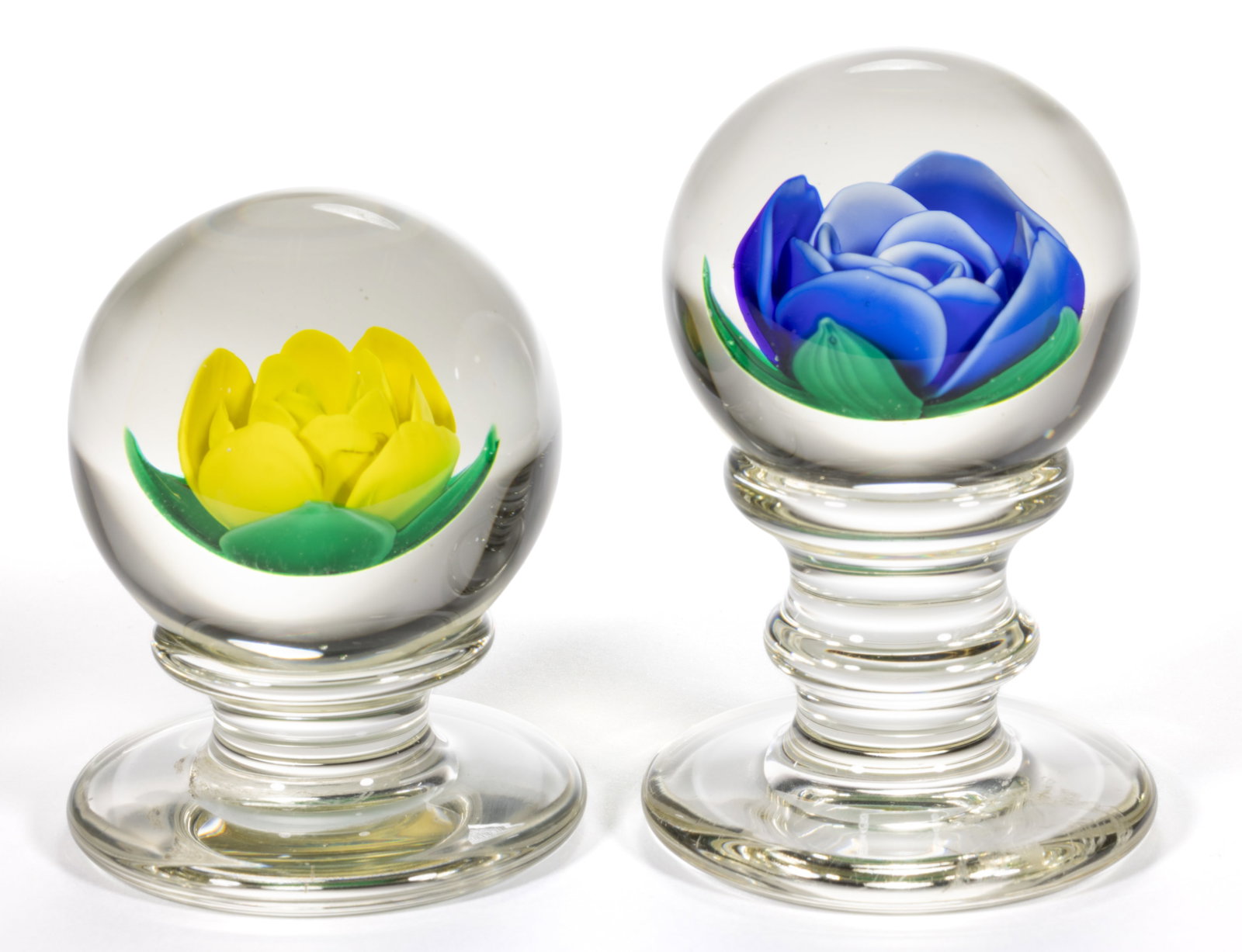FRANCIS WHITTEMORE (AMERICAN 1921-2020) CRIMP ROSE STUDIO ART GLASS PEDESTAL PAPERWEIGHTS, LOT OF: FRANCIS WHITTEMORE (AMERICAN 1921-2020) CRIMP ROSE STUDIO ART GLASS PEDESTAL PAPERWEIGHTS, LOT OF TWO, comprising a blue rose raised on a tall standard with a medial knop; and a yellow rose raised on