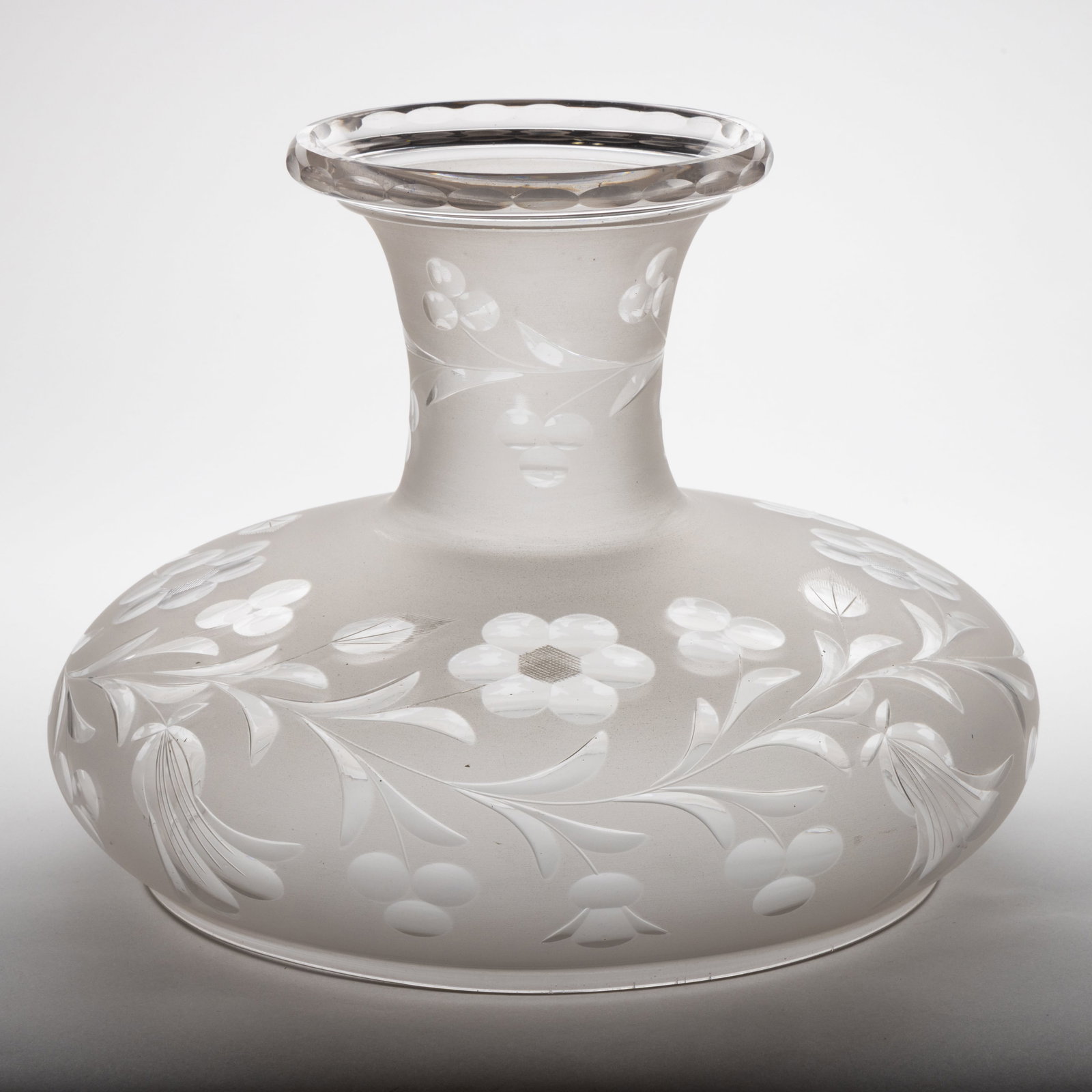 FREE-BLOWN AND CUT SINUMBRA LAMP SHADE: FREE-BLOWN AND CUT SINUMBRA LAMP SHADE, colorless with frosted finish, umbrella form, cut floral pattern with foliage, berries, and bell-type flowers, additional matching foliage cutting to the n