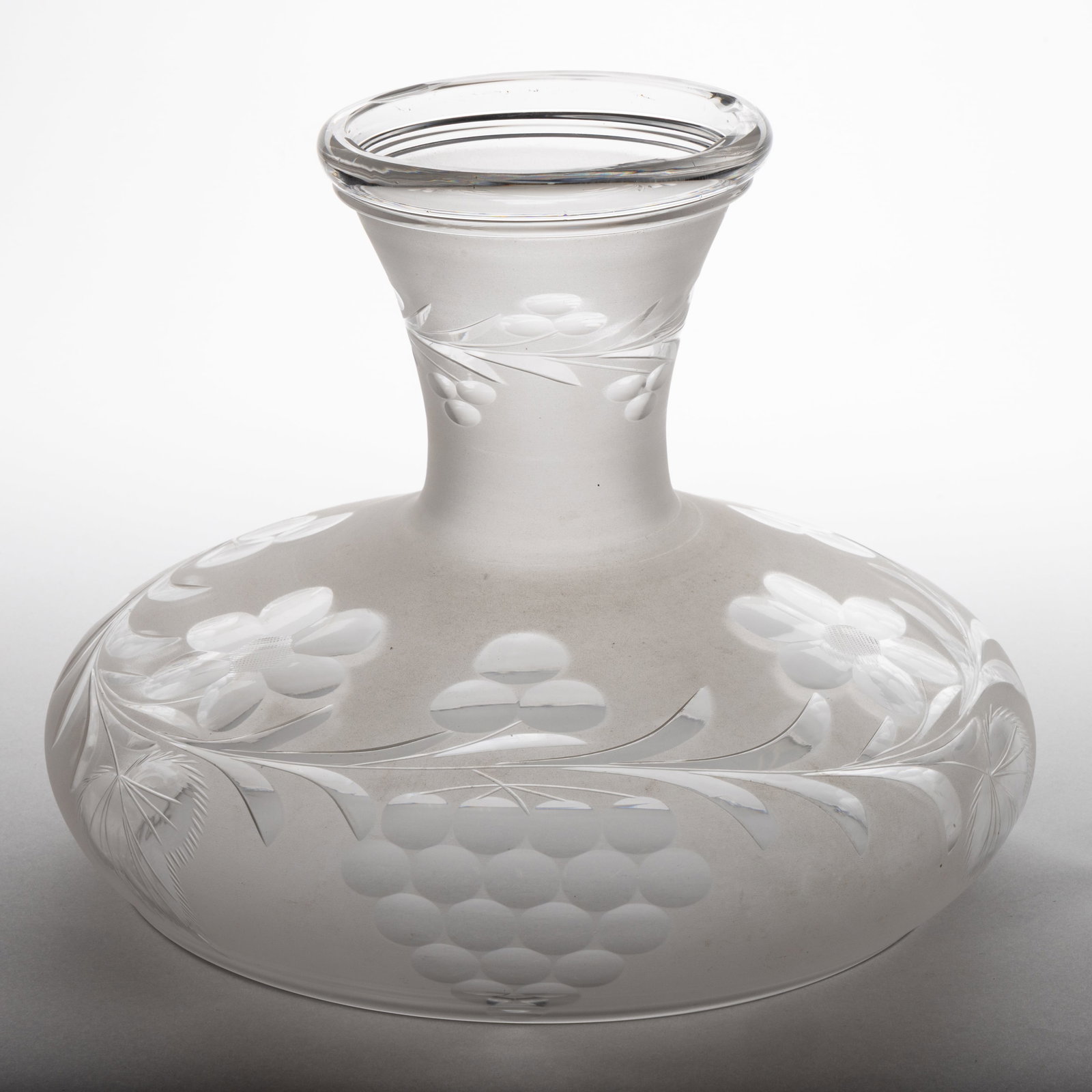 FREE-BLOWN AND CUT SINUMBRA LAMP SHADE: FREE-BLOWN AND CUT SINUMBRA LAMP SHADE, colorless with frosted finish, umbrella form, cut floral pattern with foliage and Vintage/grape decoration, neck with a matching cut floral band, plain rim