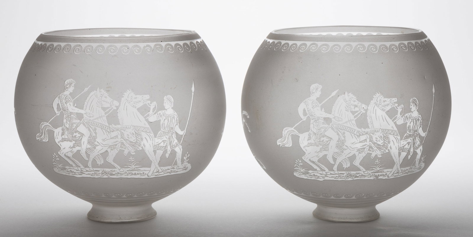 BLOWN DEEP ACID-ETCHED GAS LAMP SHADES, PAIR: BLOWN DEEP ACID-ETCHED GAS LAMP SHADES, PAIR, colorless with frosted finish, globular form, each with three various Roman Gladiator and chariot scenes between scroll bands. Probably 19th cen
