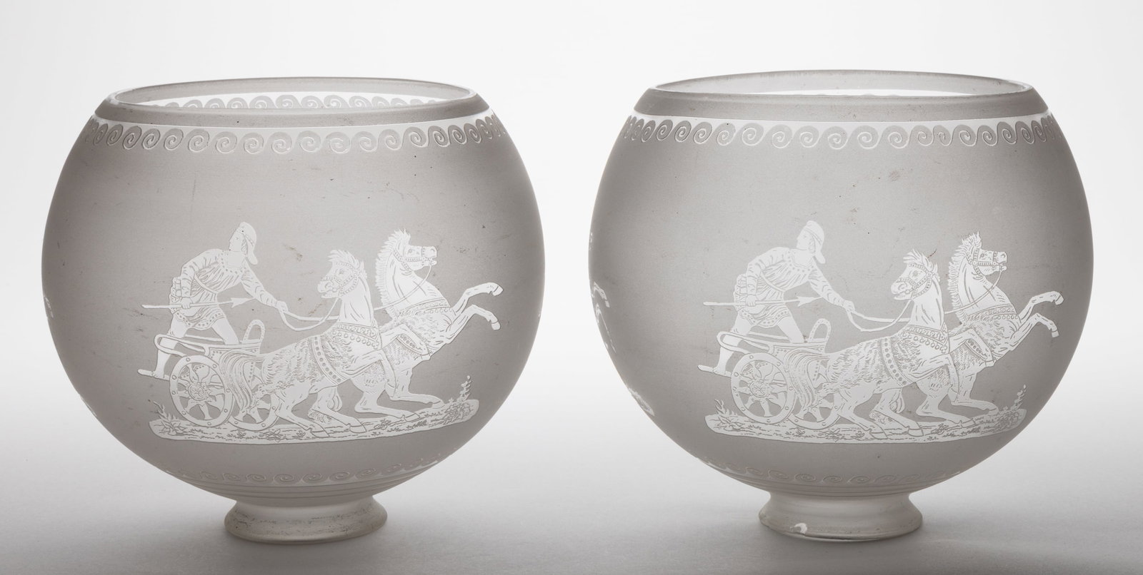 BLOWN DEEP ACID-ETCHED GAS LAMP SHADES, PAIR: BLOWN DEEP ACID-ETCHED GAS LAMP SHADES, PAIR, colorless with frosted finish, globular form, each with three various Roman Gladiator and chariot scenes between scroll bands. Probably 19th cen