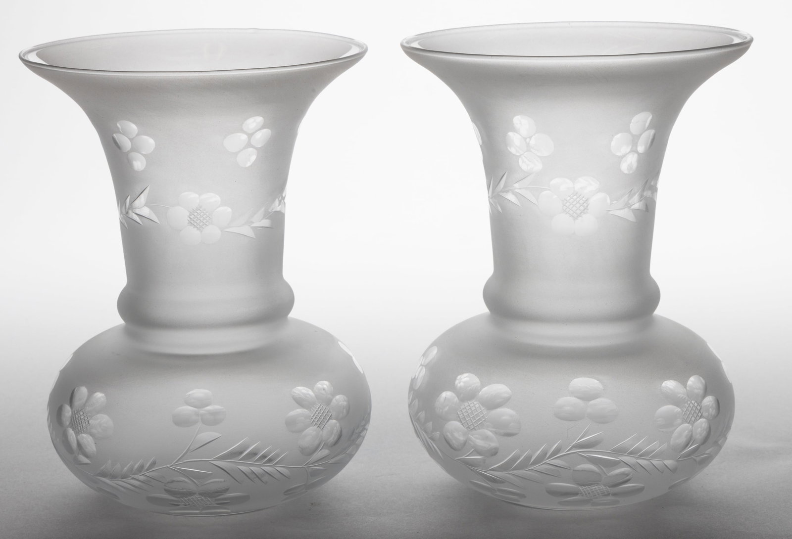 BLOWN CUT AND ENGRAVED ARGAND LAMP SHADES, PAIR: BLOWN CUT AND ENGRAVED ARGAND LAMP SHADES, PAIR, colorless with frosted finish, trumpet forms with flared rim, body with a trailing floral and foliage band, neck with matching trailing decoration and