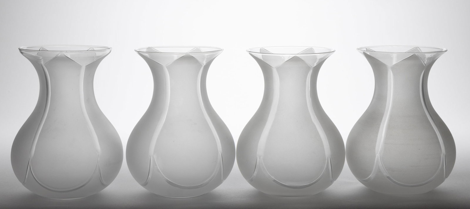 MODERN BLOWN CUT AND ENGRAVED ARGAND LAMP SHADES, SET OF FOUR: MODERN BLOWN CUT AND ENGRAVED ARGAND LAMP SHADES, SET OF FOUR, colorless with frosted finish, baluster forms with tapered rims, cut panels which form five frosted peaks to the top, lipless fitter