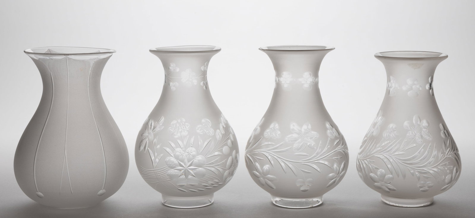 ASSORTED BLOWN CUT AND ENGRAVED ARGAND LAMP SHADES, LOT OF FOUR: ASSORTED BLOWN CUT AND ENGRAVED ARGAND LAMP SHADES, LOT OF FOUR, colorless with frosted finish, baluster forms with flared out rims, three examples with various stylized trail of foliag