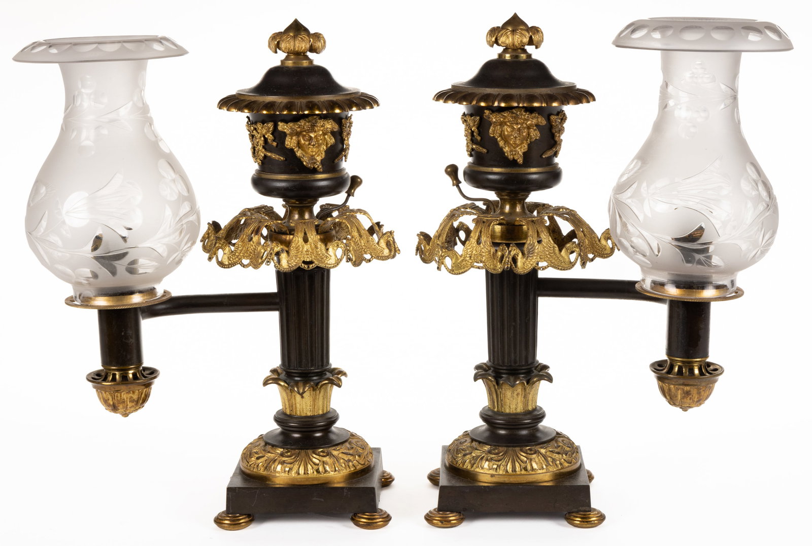 AMERICAN OR ENGLISH GILTED BRONZE / BRASS SINGLE- ARGAND LAMPS, PAIR: AMERICAN OR ENGLISH GILTED BRONZE / BRASS ARGAND LAMPS, PAIR, patinated bronze and gilded, urn-form reservoir with acanthus leaf-form finial, applied ornamentation to concave side depicting bearded he