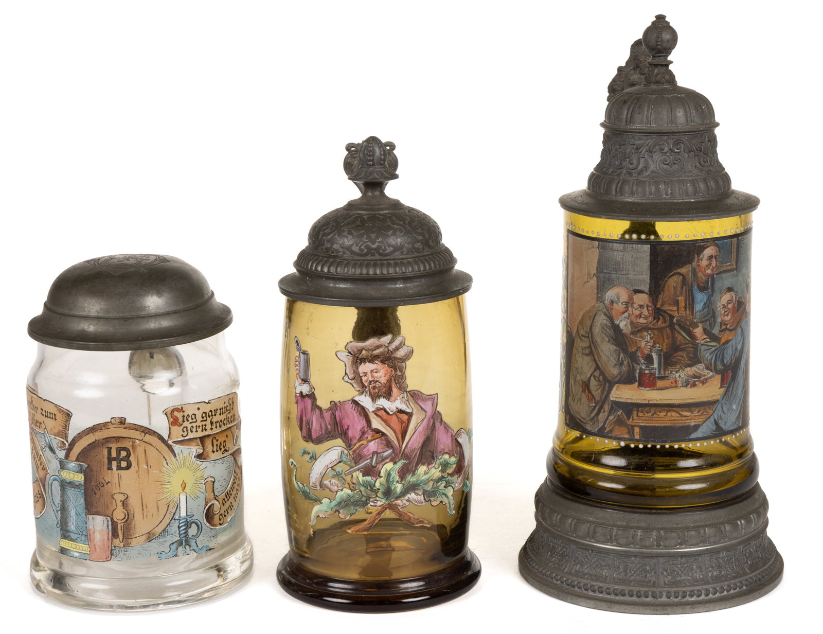 BOHEMIAN ENAMEL-DECORATED GLASS STEINS, LOT OF THREE: BOHEMIAN ENAMEL-DECORATED GLASS STEINS, LOT OF THREE, two in varying shades of amber and one colorless, comprising a barrel-form featuring a man raising a stein, a cylindrical from depicting a Bo