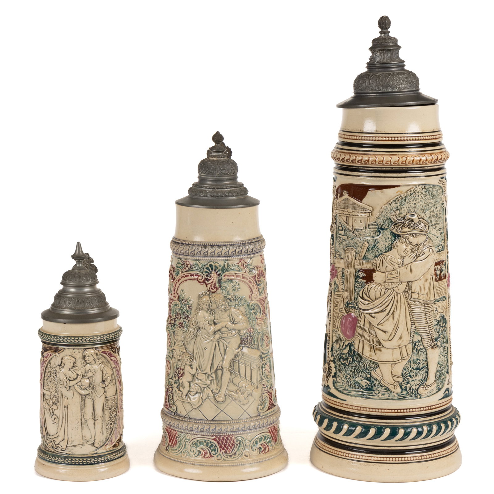 GERMAN RELIEF-DECORATED CERAMIC STEINS, LOT OF THREE (1 of 4)