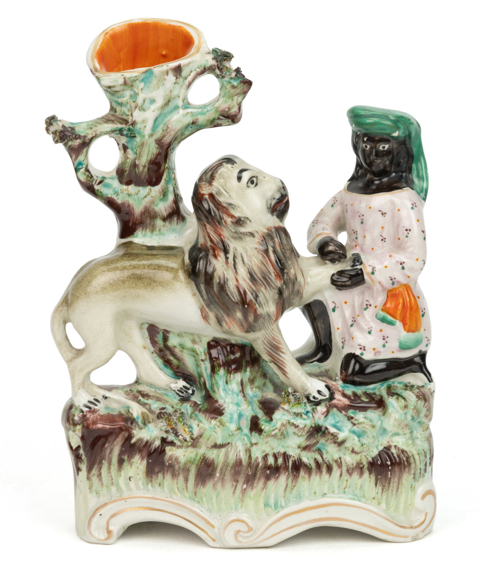 ENGLISH STAFFORDSHIRE HAND-PAINTED CERAMIC MACOMBO AND THE LION SPILL VASE FIGURAL GROUP: ENGLISH STAFFORDSHIRE HAND-PAINTED CERAMIC MACOMBO AND THE LION SPILL VASE FIGURAL GROUP, having polychrome enamel decorations and on an ovoid rococo-style base, depicting a kneeling African figure we