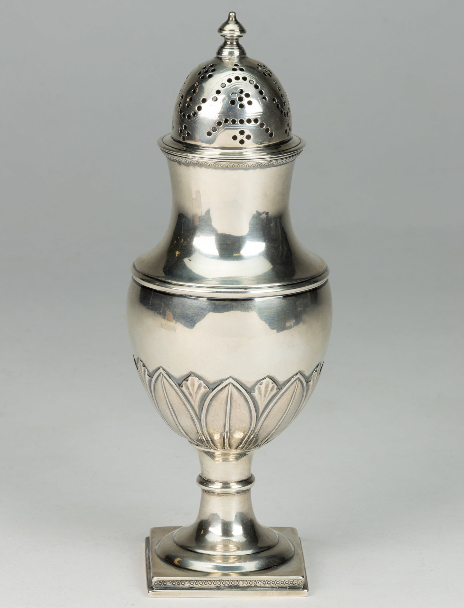 R. & W. WILSON, PHILADELPHIA, PENNSYLVANIA COIN SILVER CASTER / MUFFINEER: R. & W. WILSON, PHILADELPHIA, PENNSYLVANIA COIN SILVER CASTER / MUFFINEER, shouldered form with narrow neck and a semi-ovoid well with repousse and chased leaf base, raised on a square foot with a