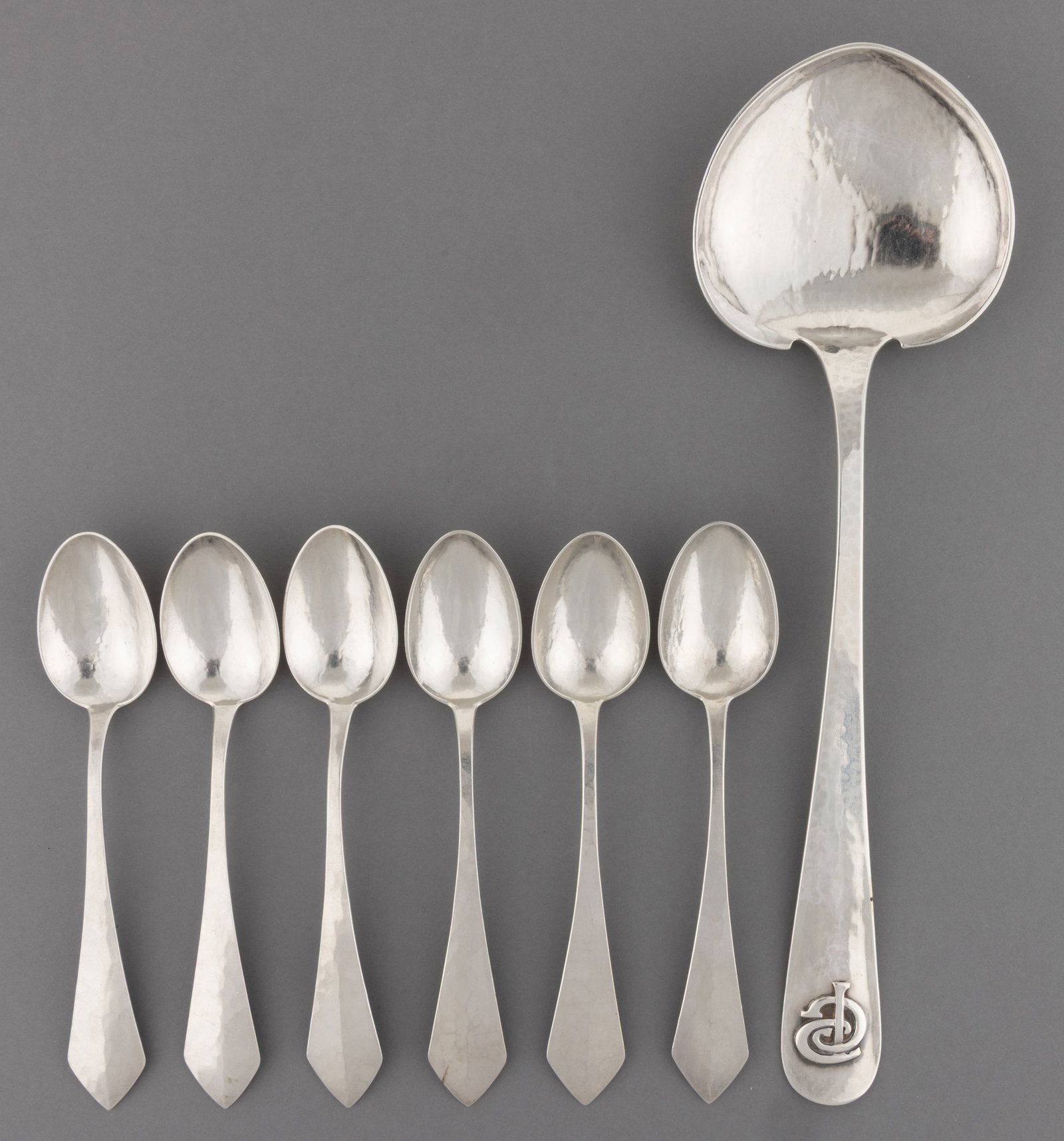 THE KALO SHOP ARTS AND CRAFTS STERLING SILVER SPOONS, LOT OF SEVEN: THE KALO SHOP ARTS AND CRAFTS STERLING SILVER SPOONS, LOT OF SEVEN, each piece having all-over hammered texture, comprising a serving spoon having a shaped bowl on a tapered handle with rounded t