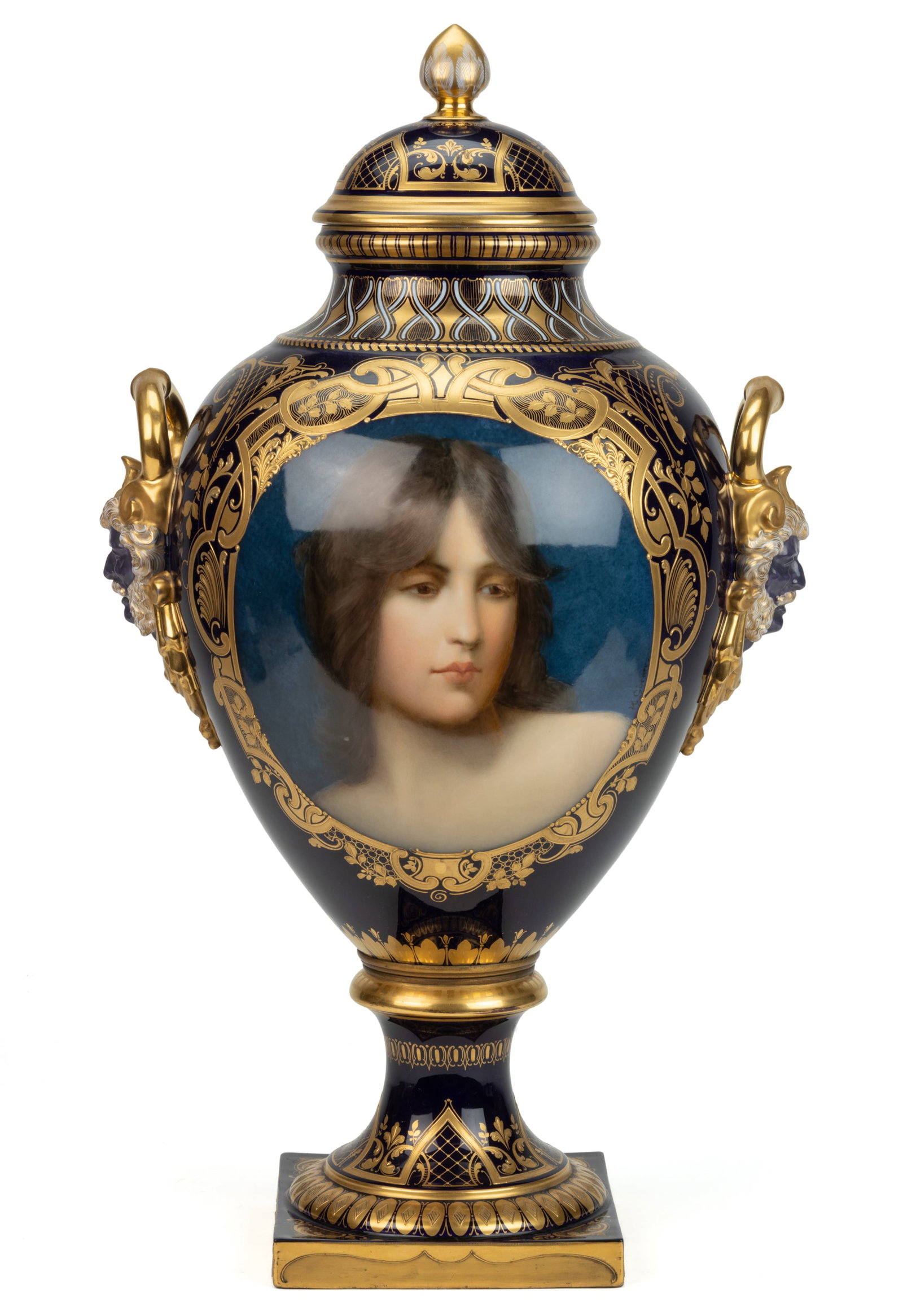 VIENNA, AUSTRIA PORCELAIN COBALT PORTRAIT BOLTED URN: VIENNA, AUSTRIA PORCELAIN COBALT PORTRAIT BOLTED URN, baluster form having mask handles featuring a purple-faced figure with white and gilt-accented hulihee beard and open loops to top, one