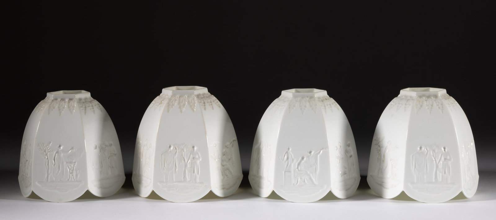 ENGLISH WEDGWOOD PORCELAIN INTAGLIO-DECORATED SHADES, LOT OF FOUR: ENGLISH WEDGWOOD PORCELAIN INTAGLIO-DECORATED SHADES, LOT OF FOUR, each of hexagonal umbrella form, featuring various neoclassical figures to each panel and acanthus leaf border. Brown-printed &q