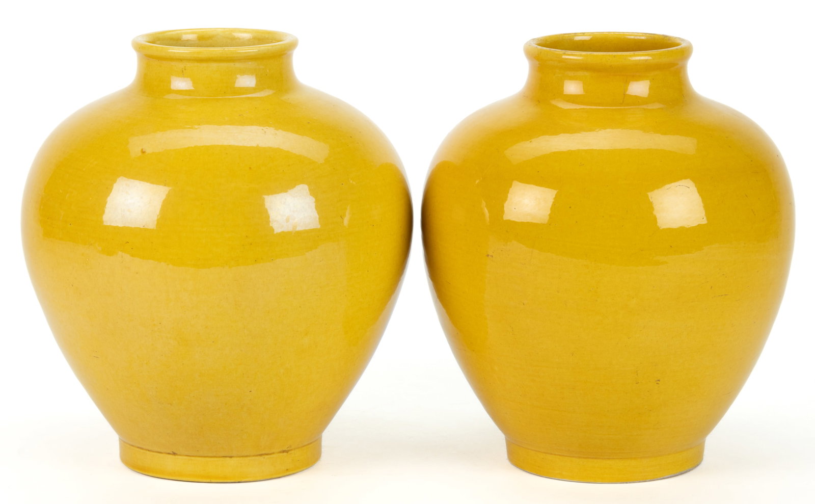 CHINESE EXPORT PORCELAIN YELLOW-GLAZED JAR / VASE PAIR: CHINESE EXPORT PORCELAIN YELLOW-GLAZED JAR / VASE PAIR, ovoid form with rounded rims. Having impressed Jianding seal mark to underside. 20th century. 9" HOA. Provenance: Property from the estate