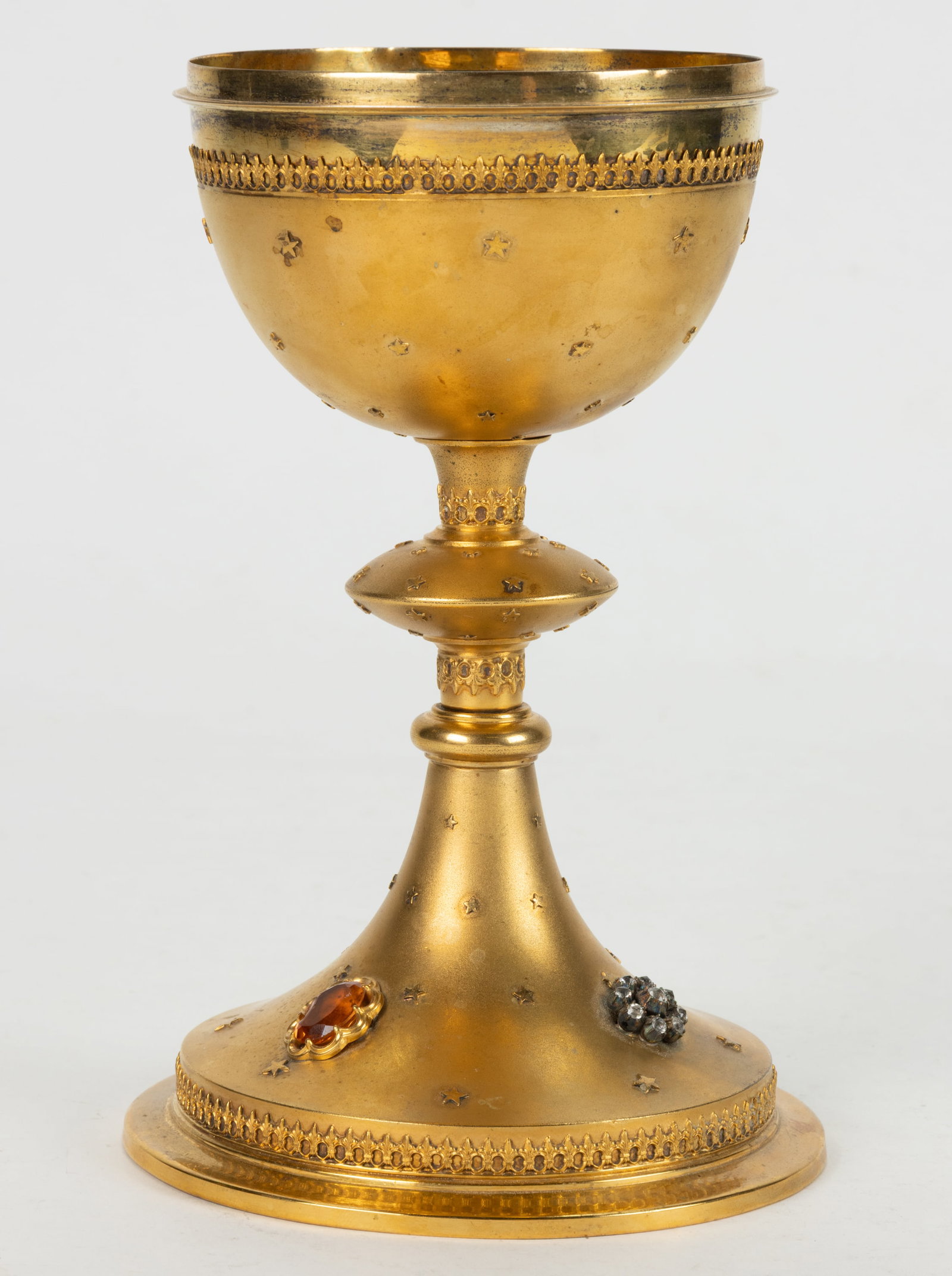 FRENCH GILT 0.950 SILVER, AND POSSIBLY OTHER METAL, CIBORIUM: FRENCH GILT 0.950 SILVER, AND POSSIBLY OTHER METAL, CIBORIUM, lacking cover, having a round well in a mount, raised on a knopped stem and round foot, featuring fleur-de-lis bands and scattered five-po