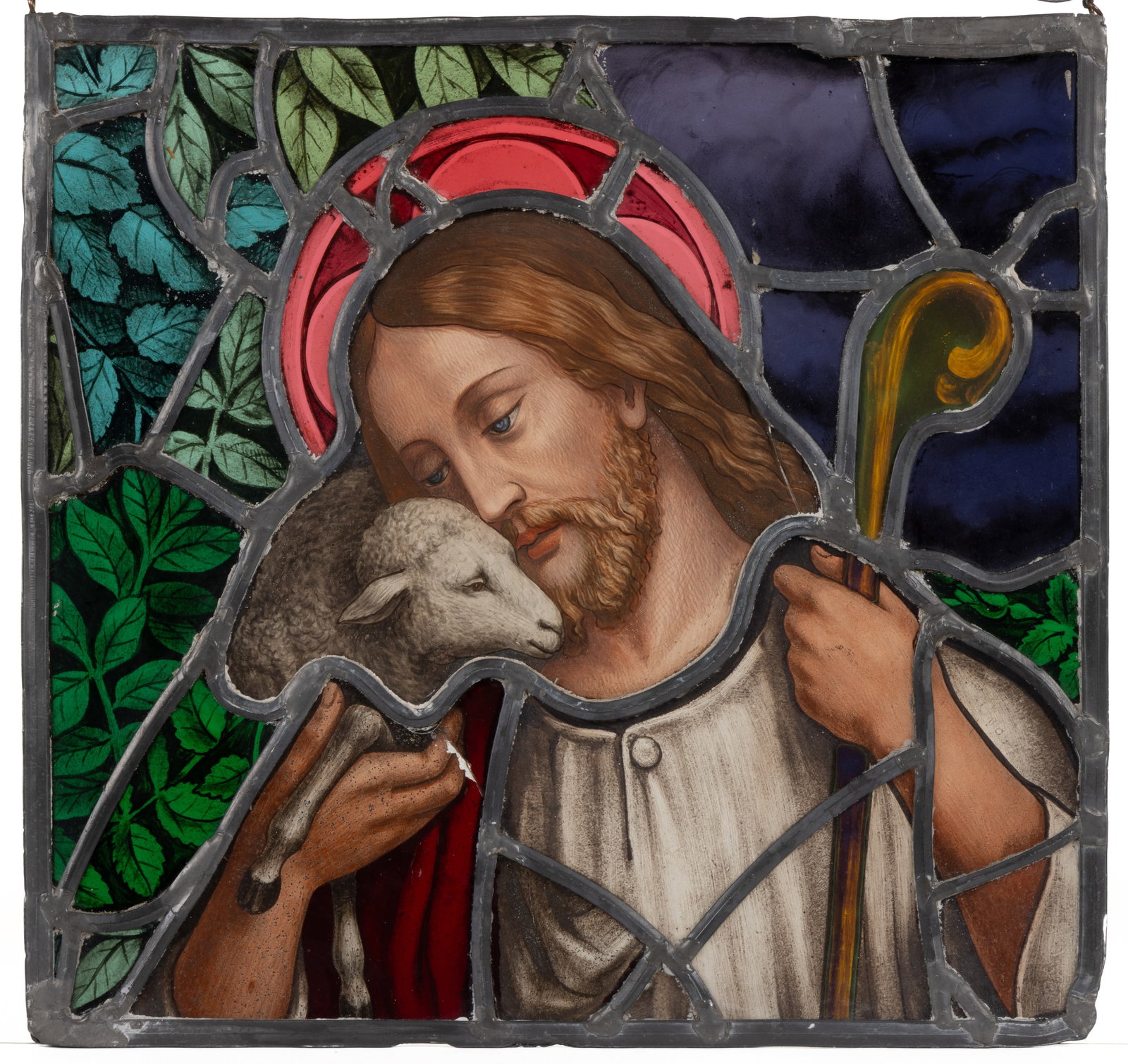 EUROPEAN RELIGIOUS STAINED- AND LEADED-GLASS WINDOW: EUROPEAN RELIGIOUS STAINED- AND LEADED-GLASS WINDOW, stained glass with most pieces having paint-decoration, square lead frame, depicting a portrait of Jesus holding a lamb, wire hanger. Late 19t