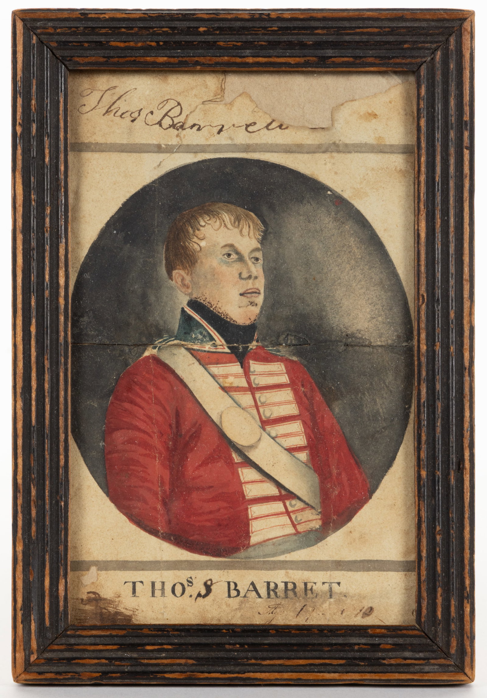 BRITISH SCHOOL (19TH CENTURY) FOLK ART PORTRAIT OF A MILITARY OFFICER: BRITISH SCHOOL (19TH CENTURY) FOLK ART PORTRAIT OF A MILITARY OFFICER, watercolor on paper, depicting a young man dressed in a formal red military officer's uniform, titled/identified "THOS.