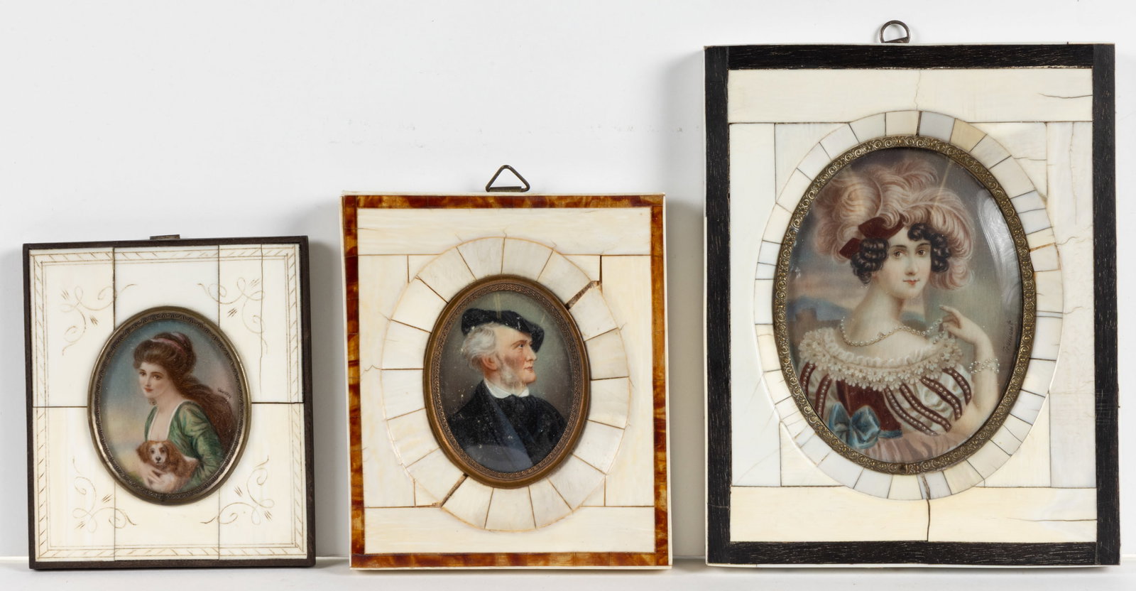 CONTINENTAL SCHOOL (20TH CENTURY) MINIATURE PORTRAITS, LOT OF THREE: CONTINENTAL SCHOOL (20TH CENTURY) MINIATURE PORTRAITS, LOT OF THREE, comprising an example of a lady holding her spaniel; a lady with a large pearl necklace and a feathered hat; and an example depicti