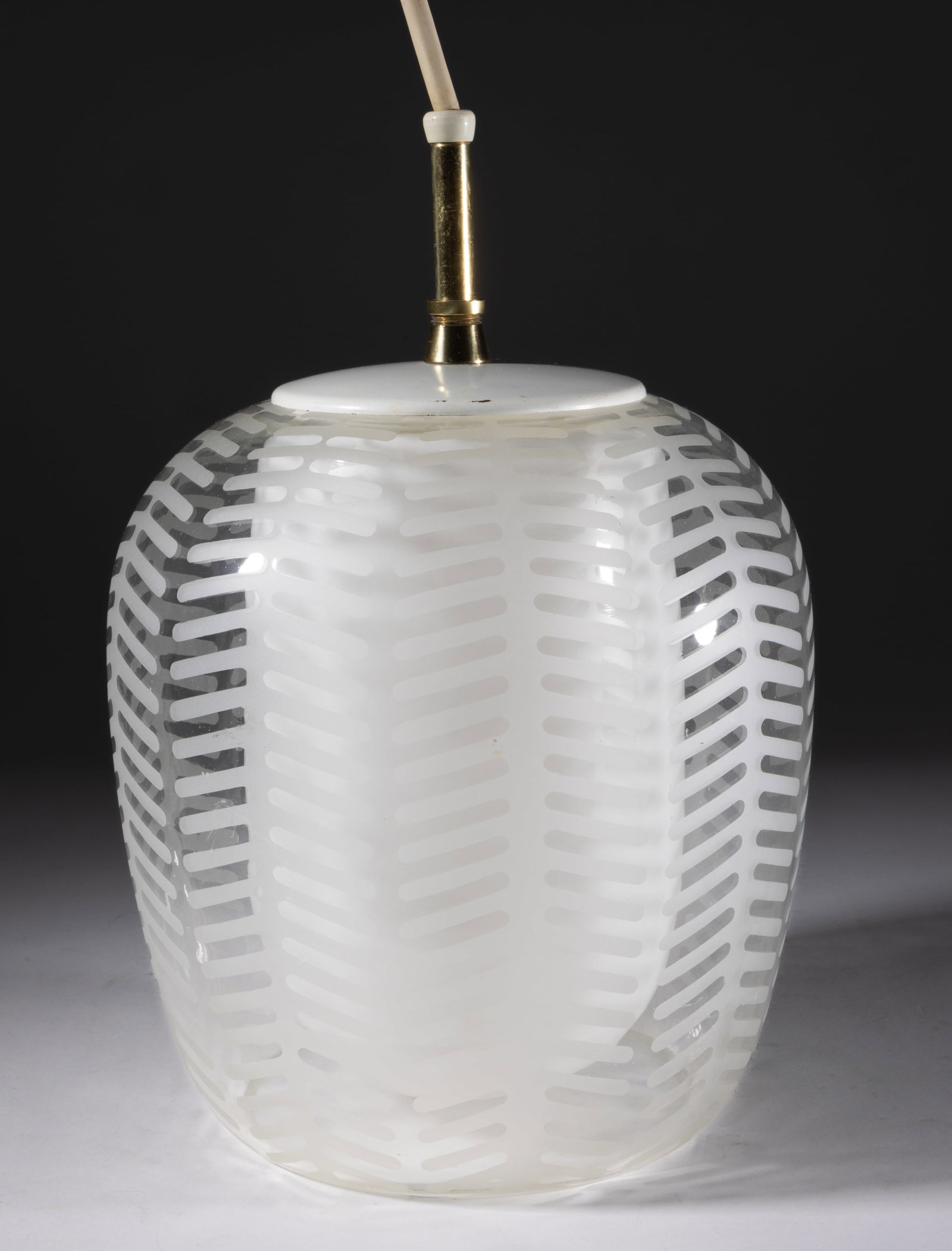 AFTER WILHELM WAGENFELD (GERMAN, 1900-1990) MID-CENTURY MODERN PENDANT / HANGING LAMP: AFTER WILHELM WAGENFELD (GERMAN, 1900-1990) MID-CENTURY MODERN PENDANT / HANGING LAMP, the colorless shade etched with a vertical stylized-fern pattern, the interior opal globe enclosing a single Levi