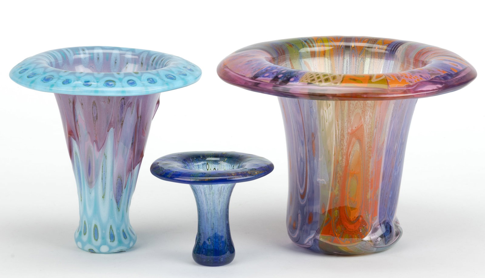 HIGGINS MID-CENTURY MODERN FUSED ART GLASS VASES, LOT OF THREE: HIGGINS MID-CENTURY MODERN FUSED ART GLASS VASES, LOT OF THREE, various colors, comprising a large amethyst, green, and orange example with playful design mixing foliate patterning, polka dots, a