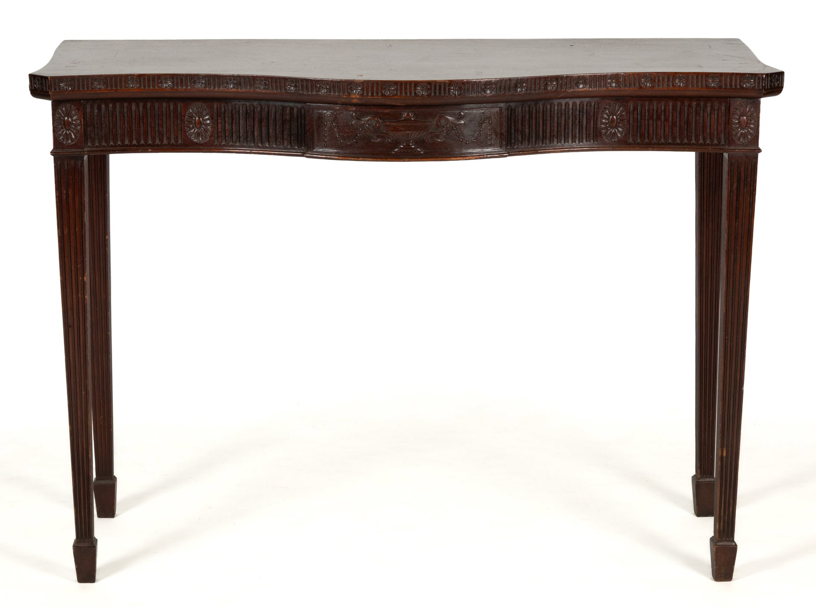 ENGLISH GEORGIAN-STYLE CARVED MAHOGANY BOW-FRONT PIER / HALL TABLE: ENGLISH GEORGIAN-STYLE CARVED MAHOGANY BOW-FRONT PIER / HALL TABLE, the shaped top with a carved edge over a skirt following the same profile having a similar carved motif with a central urn-and-garla
