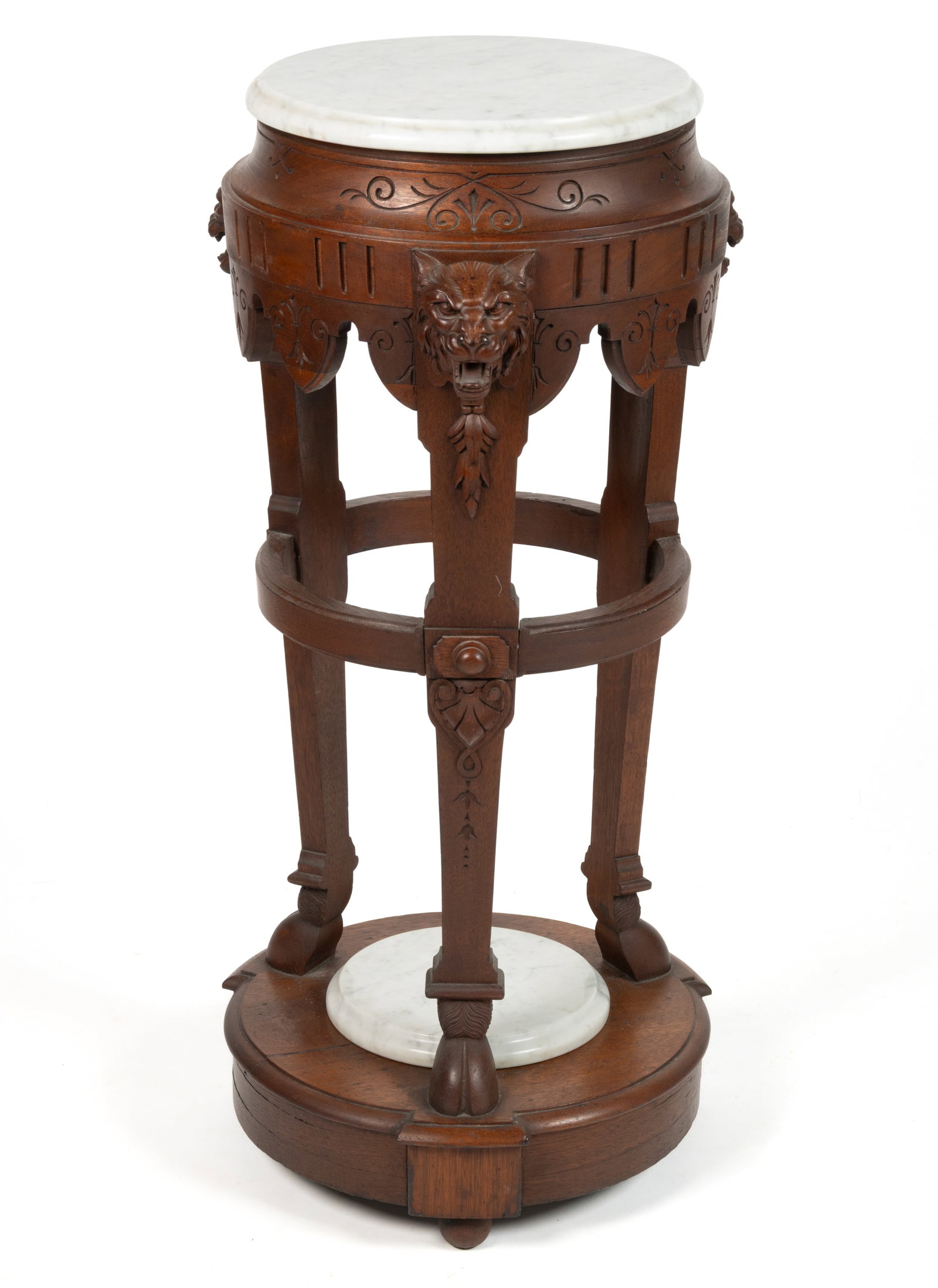 AMERICAN VICTORIAN CARVED WALNUT MARBLE-TOP PEDESTAL / FERN STAND: AMERICAN VICTORIAN CARVED WALNUT MARBLE-TOP PEDESTAL / FERN STAND, the round marble top over a carved apron supported by three shaped legs with applied cat-head carving at the top and hoof feet which