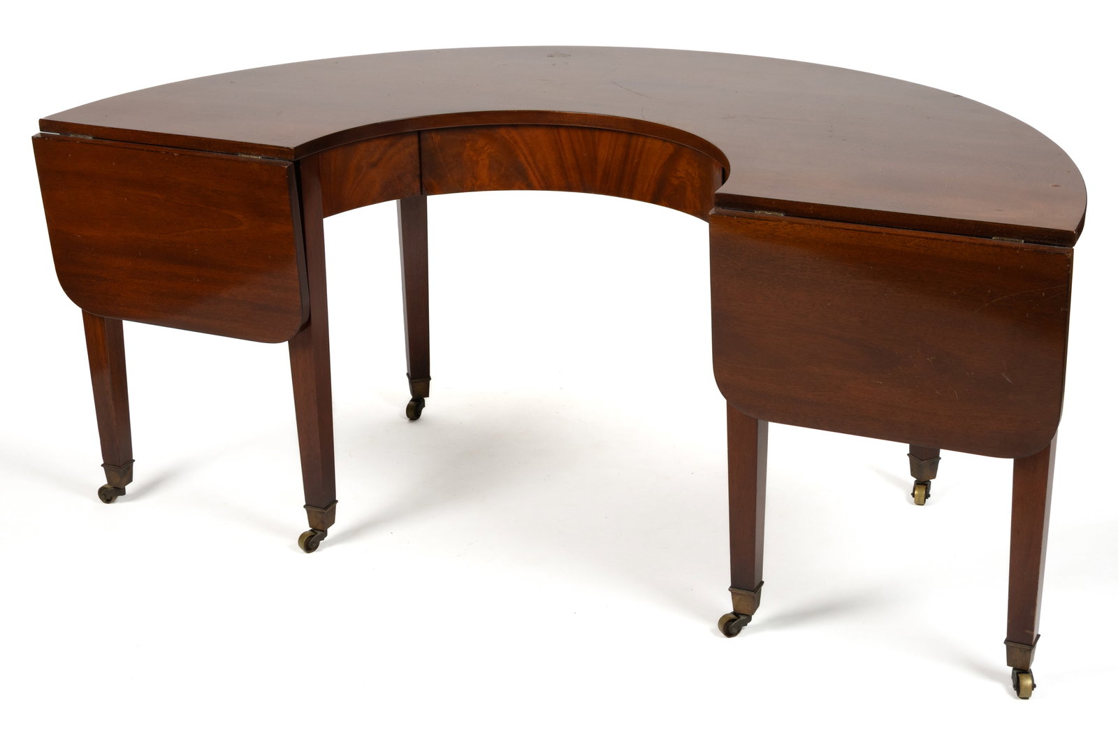BEACON HILL REGENCY-STYLE MAHOGANY COFFEE TABLE: BEACON HILL REGENCY-STYLE MAHOGANY COFFEE TABLE, demilune form with single drawer, two hinged fall leaves, and square-tapered legs fitted with brass casters, retaining printed label to interior of dra