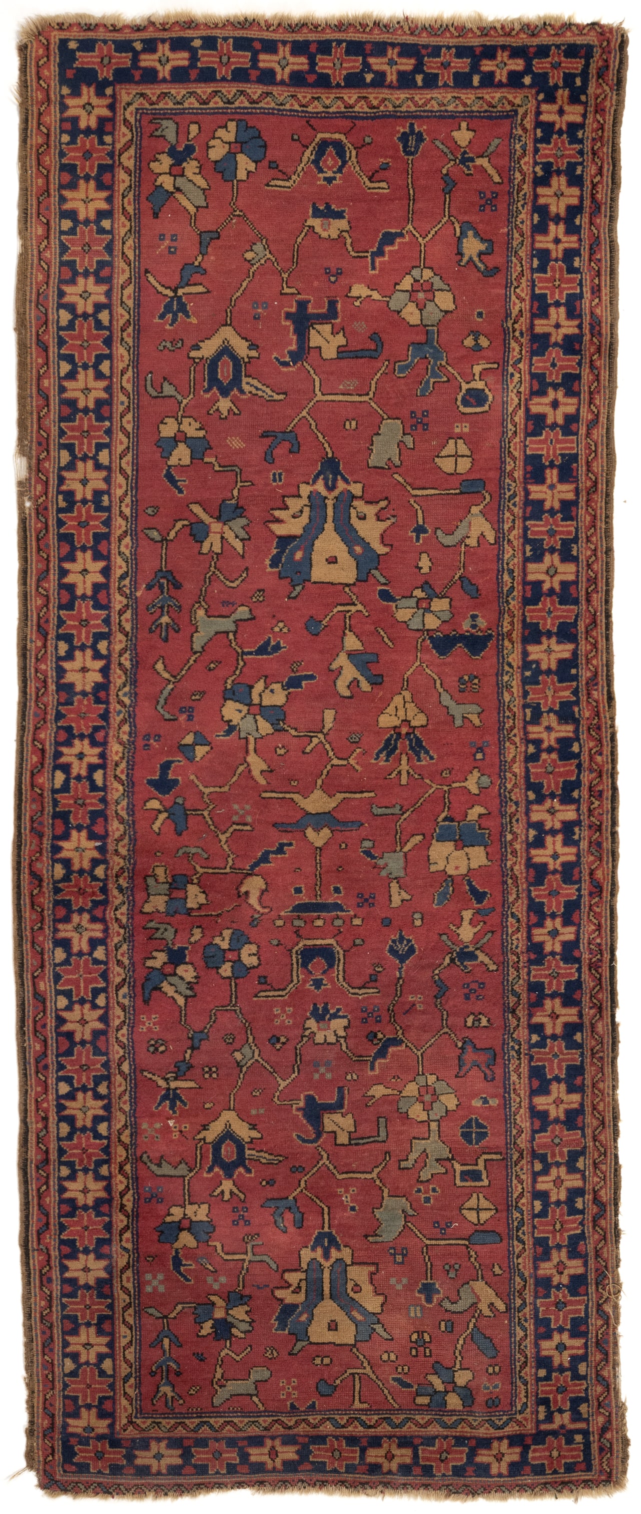 SEMI-ANTIQUE CAUCASIAN RUNNER RUG / CARPET: SEMI-ANTIQUE CAUCASIAN RUNNER RUG / CARPET, with a red center field with various stylized floral and fauna designs in golds, blues, and light greens, surrounded by an inner and outer guard board with