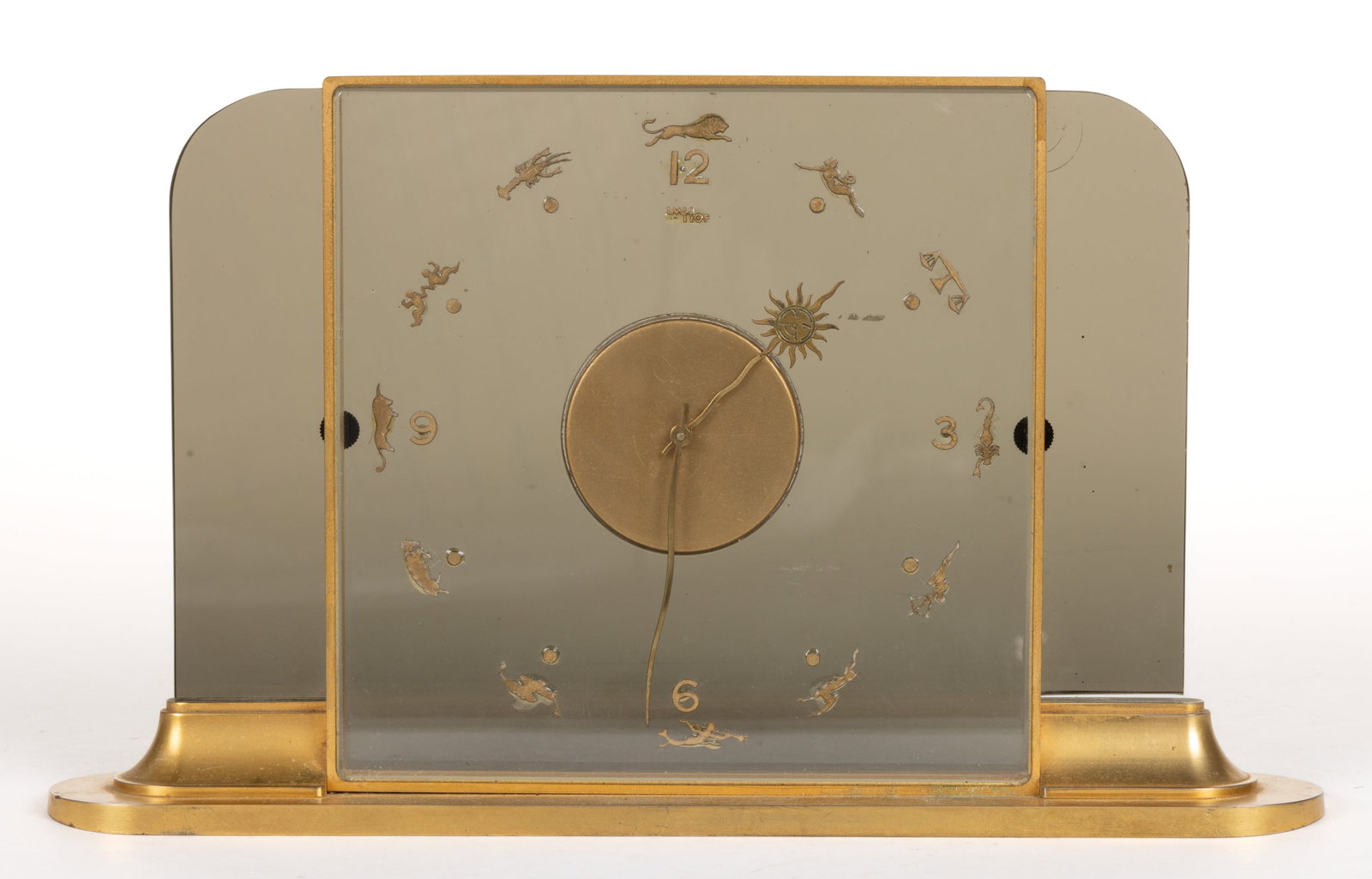 SWISS SIGNED IMHOFF GILT-BRASS ART DECO ZODIAC 15-JEWEL DESK CLOCK: SWISS SIGNED IMHOFF GILT-BRASS ART DECO ZODIAC 15-JEWEL DESK CLOCK, square-form clock with smoky glass panels, having the numerals 12, 3, 6, and nine, each numeral location with a zodiac symbol, proba