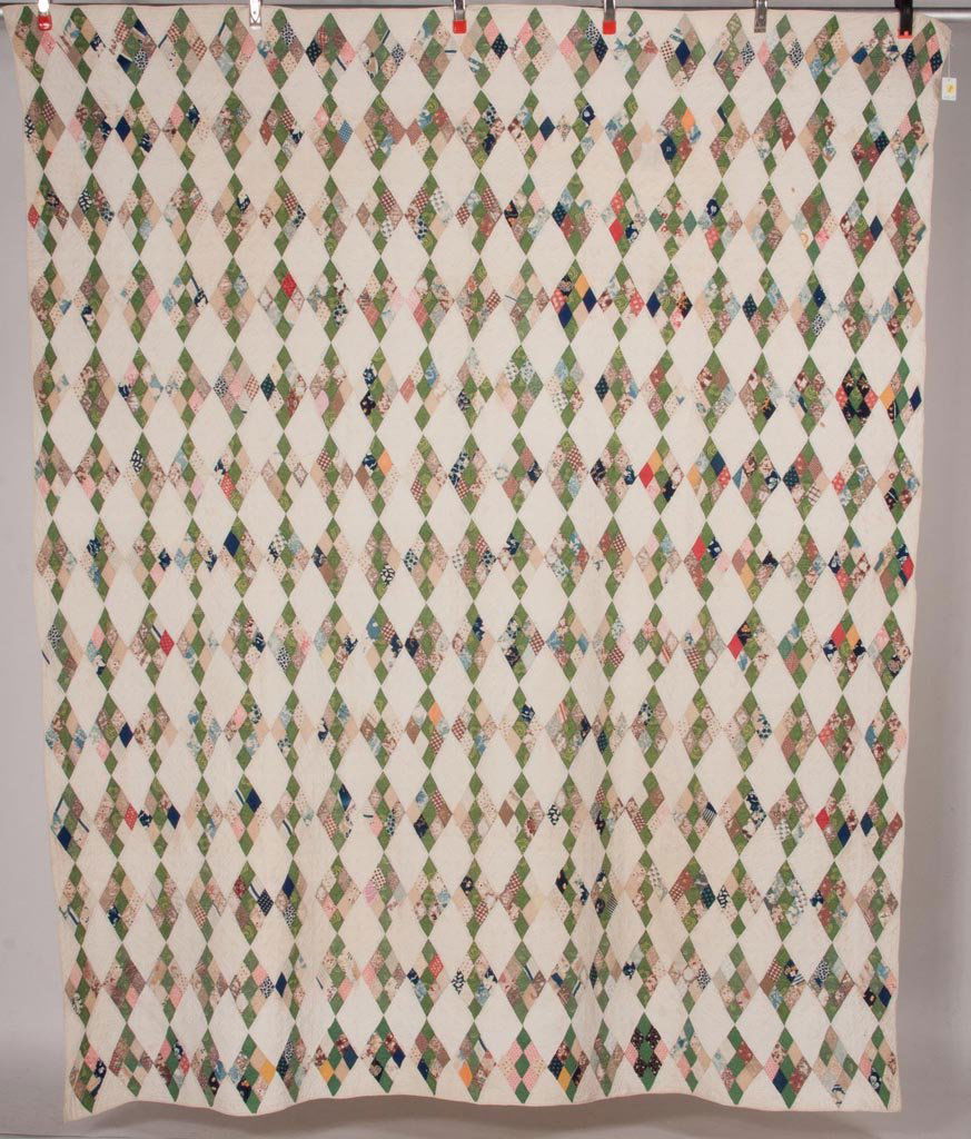 MID-ATLANTIC PIECED NINE-PATCH DIAMOND QUILT: MID-ATLANTIC PIECED NINE-PATCH DIAMOND QUILT, 247 diamonds in various colored prints and solids, hand quilting comprising double cross-hatching and borders with chevron. Possibly Shenandoah Valley of