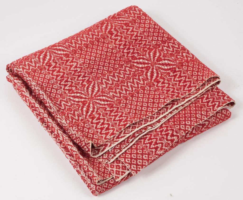 MID-ATLANTIC OVERSHOT COVERLET: MID-ATLANTIC OVERSHOT COVERLET, in two joined panels, red and white, four petals with alternating blocks and waves. Second half 19th century. 80" x 72". Provenance: The estate collection of Richard an