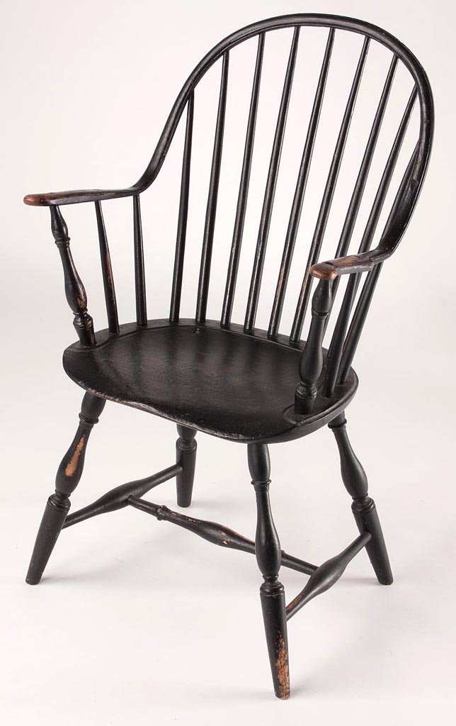 PENNSYLVANIA CONTINUOUS-ARM WINDSOR ARMCHAIR: PENNSYLVANIA CONTINUOUS-ARM WINDSOR ARMCHAIR, nine-spindle back and shaped arms above a saddle seat, raised on turned legs. Old worn black-painted surfaces. Fourth quarter 18th century. 38 1/4" HOA, 1