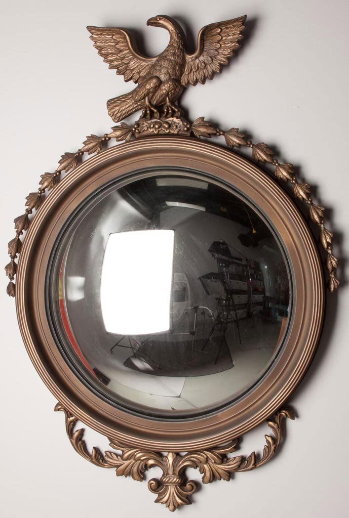 NEO-CLASSICAL STYLE GILTWOOD CONVEX WALL MIRROR: NEO-CLASSICAL STYLE GILTWOOD CONVEX WALL MIRROR, spread-wing eagle crest. 20th century. 46 1/2" HOA, 23 1/2" D mirror. Provenance: From a Riverside, IL family collection.