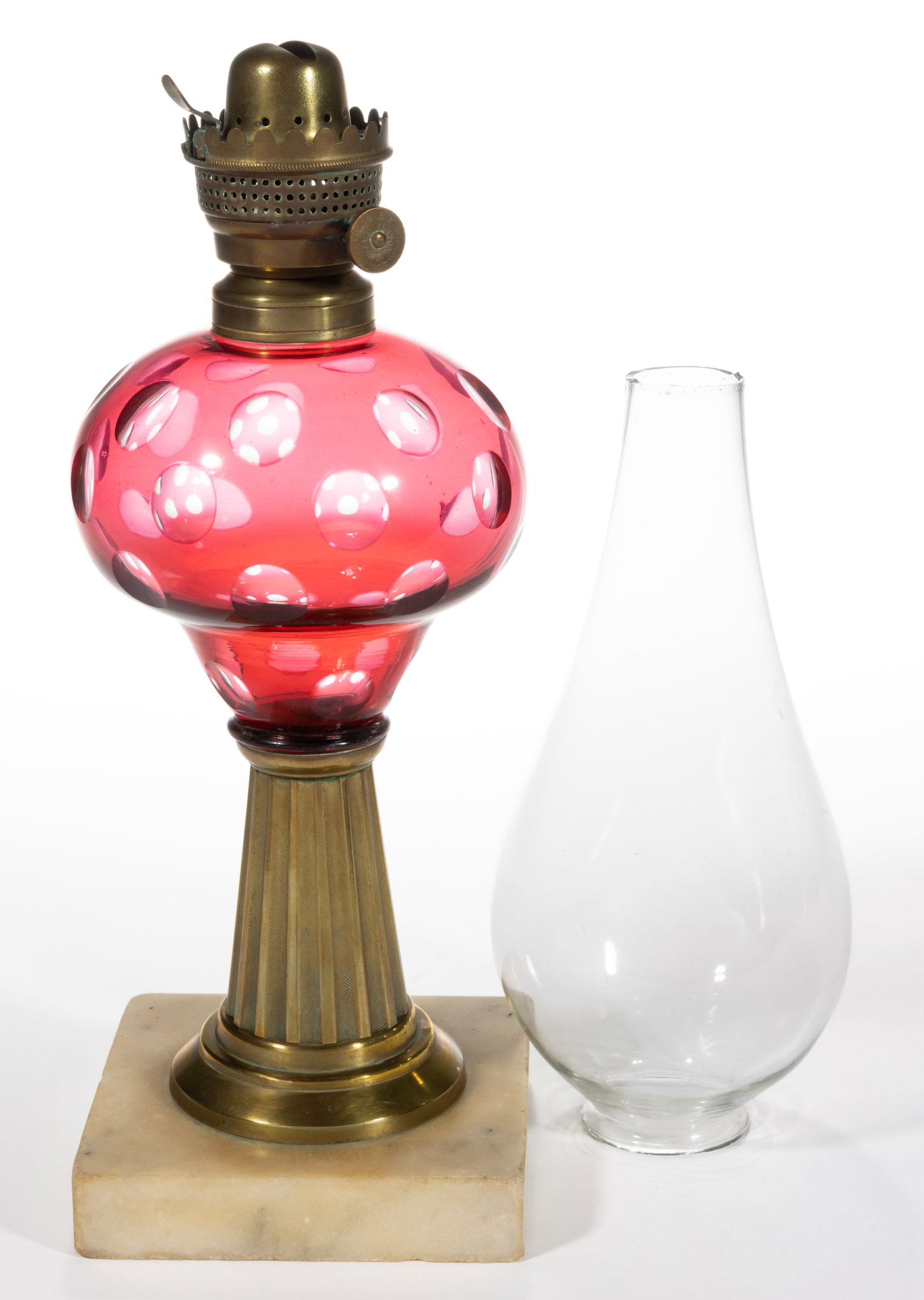 CUT OVERLAY PUNTY KEROSENE STAND LAMP: CUT OVERLAY PUNTY KEROSENE STAND LAMP, cased ruby/cranberry to colorless, bulbous pyriform font, brass ribbed stem and single-step marble foot, brass No. 1 fine-line collar, colorless wafer 