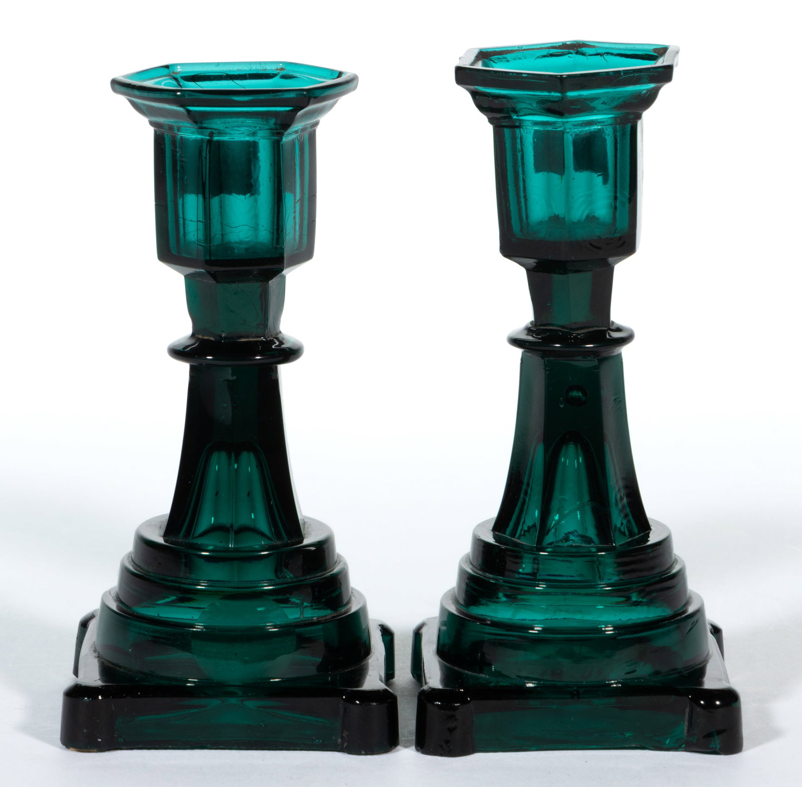 EXTREMELY RARE PRESSED HEXAGONAL SOCKET DIMINUTIVE PAIR OF CANDLESTICKS: EXTREMELY RARE PRESSED HEXAGONAL SOCKET DIMINUTIVE PAIR OF CANDLESTICKS, deep brilliant peacock green, simple straight-sided socket with a short lower extension raised on a tapered hexagonal stem,
