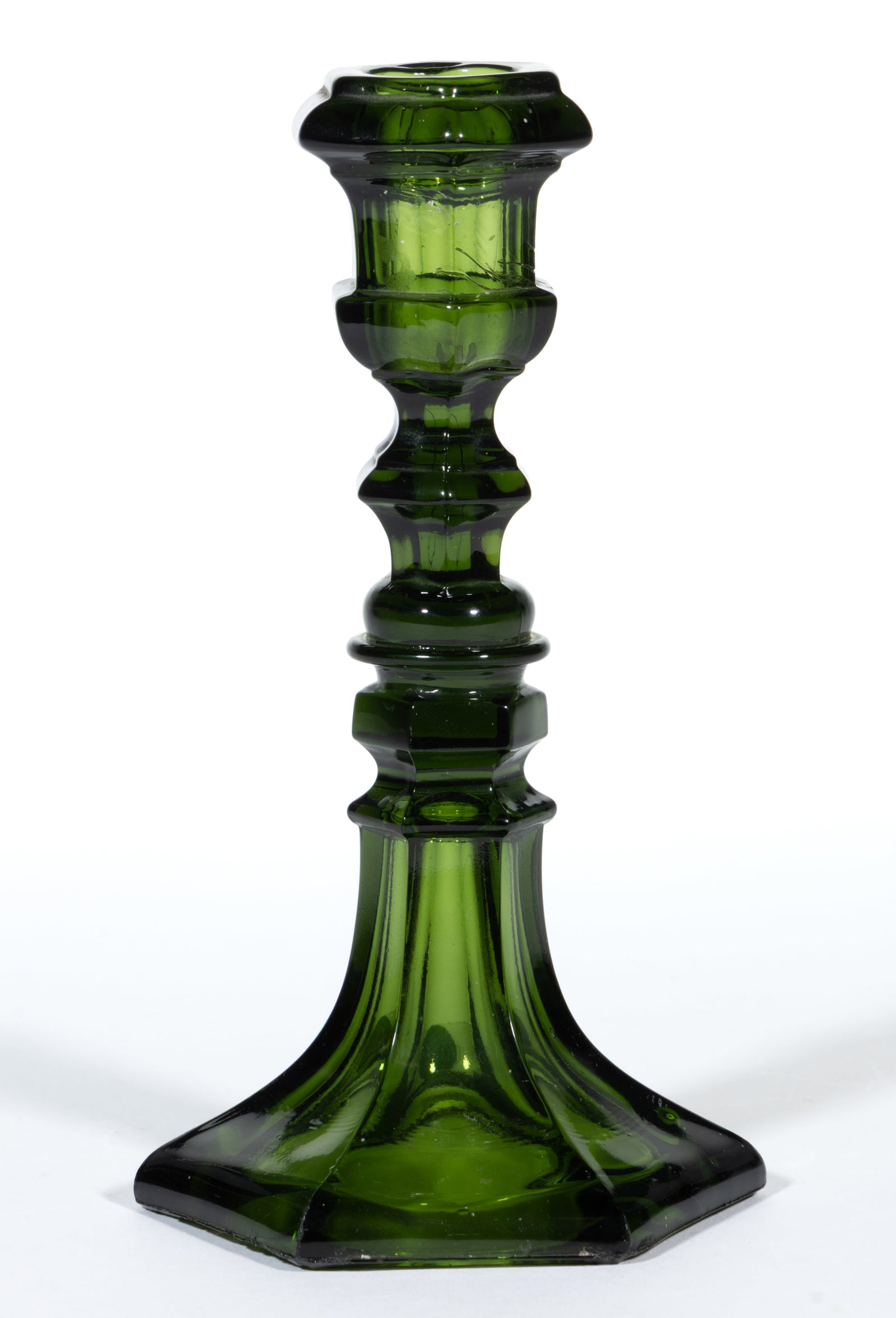 PRESSED HEXAGONAL CANDLESTICK: PRESSED HEXAGONAL CANDLESTICK, dark olive green, thick-lipped socket with a compressed-knop lower extension, raised on hexagonal knop and flared base, wafer construction. New England. 1850-1870. 7 1/2
