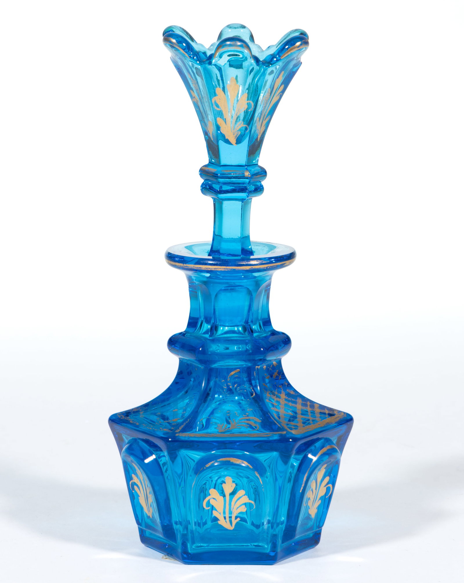 PRESSED OVAL PANELED FRAMES COLOGNE BOTTLE: PRESSED OVAL PANELED FRAMES COLOGNE BOTTLE, brilliant electric blue with gilt decorations, hexagonal form with a ringed and panel-cut neck, factory polished flanged mouth and pontil mark, with origina