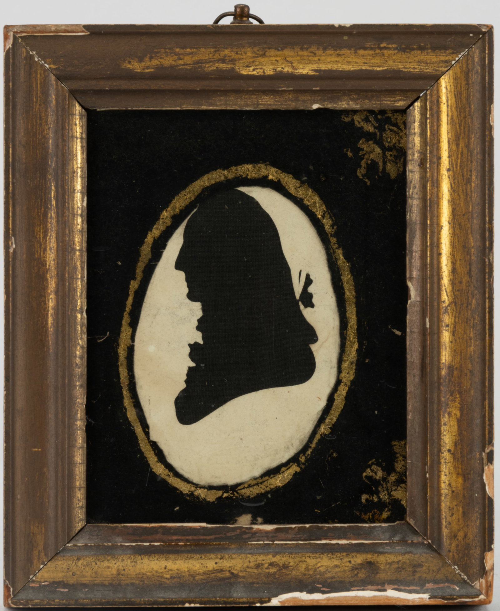 PEALES MUSEUM HOLLOW-CUT SILHOUETTE OF A GENTLEMAN: PEALES MUSEUM HOLLOW-CUT SILHOUETTE OF A GENTLEMAN, probably a depiction of George Washington, laid on a black fabric backing, embossed "PEALES MUSEUM" in a banner below a spread-wing