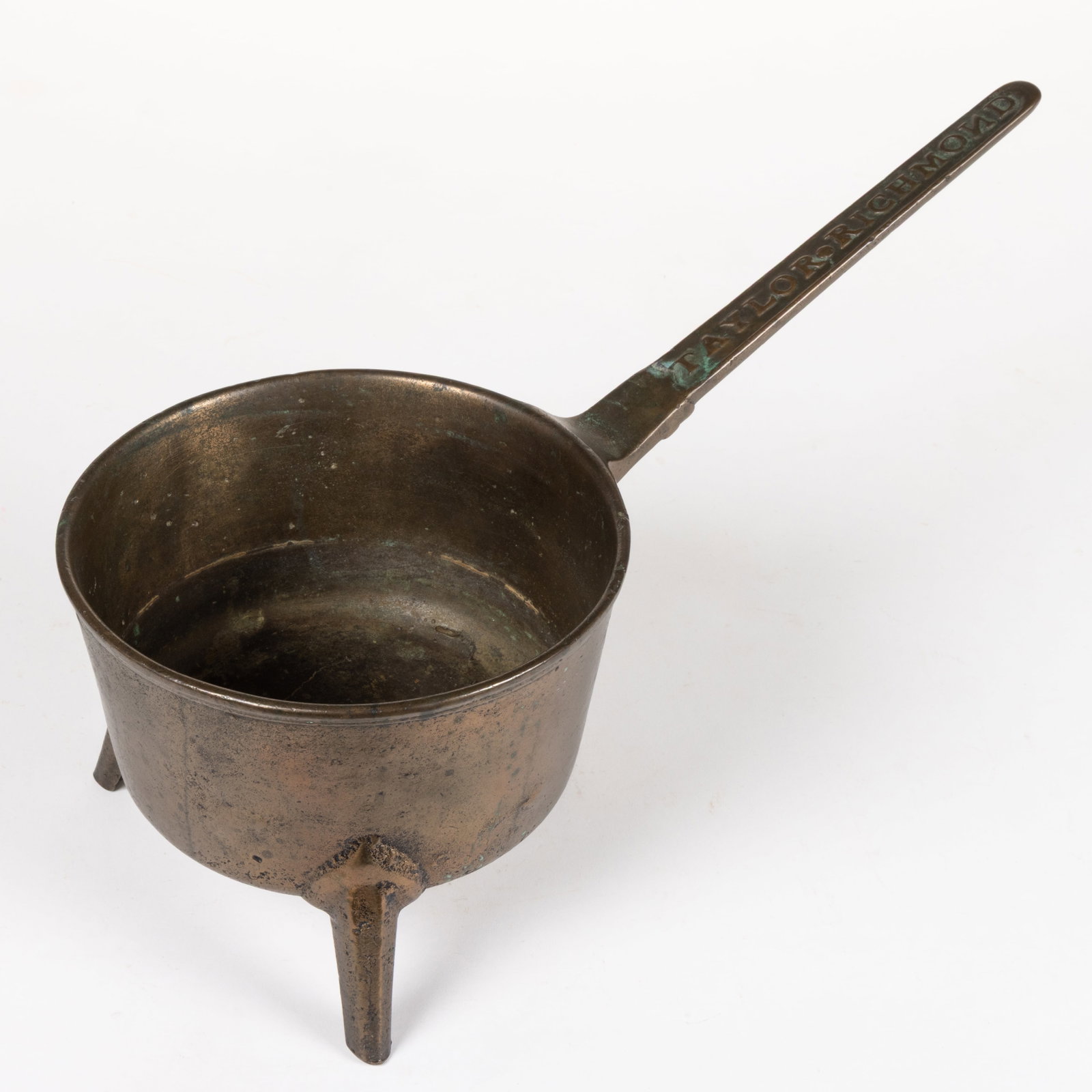JOHN TAYLOR, RICHMOND, VIRGINIA BELL METAL / BRONZE POSNET: JOHN TAYLOR, RICHMOND, VIRGINIA BELL METAL / BRONZE POSNET, deep, circular pot with molded outer rim, and integral, angled tapering handle intaglio stamped "TAYLOR * RICHMOND" to t