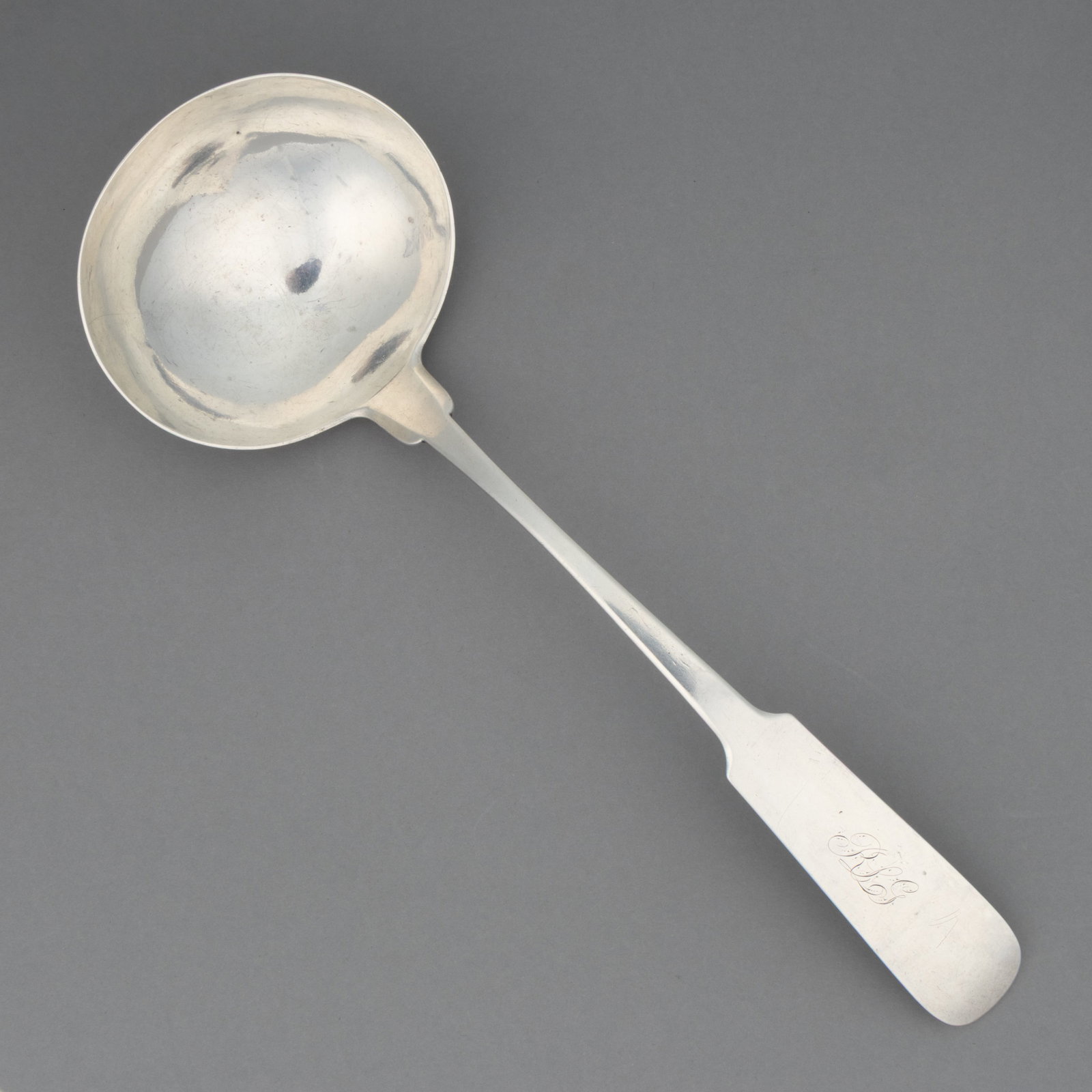 WILLIAM MITCHELL, JR., RICHMOND, VIRGINIA COIN SILVER PUNCH / SOUP LADLE: WILLIAM MITCHELL, JR., RICHMOND, VIRGINIA COIN SILVER PUNCH / SOUP LADLE, ovoid bowl on a backwards-tipped fiddle handle with pointed shoulders and engraved "RLG" initials. Impressed to back