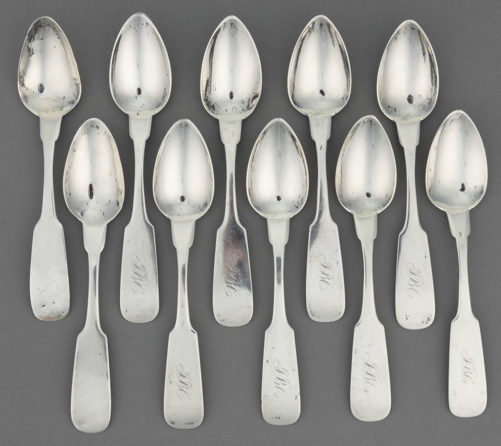 MITCHELL & TYLER, RICHMOND, VIRGINIA COIN SILVER TEASPOONS, ASSEMBLED SET OF TEN: MITCHELL & TYLER, RICHMOND, VIRGINIA COIN SILVER TEASPOONS, ASSEMBLED SET OF TEN, each having a pointed oval bowl on a backwards-tipped fiddle handle with pointed shoulders, comprising a set of ei